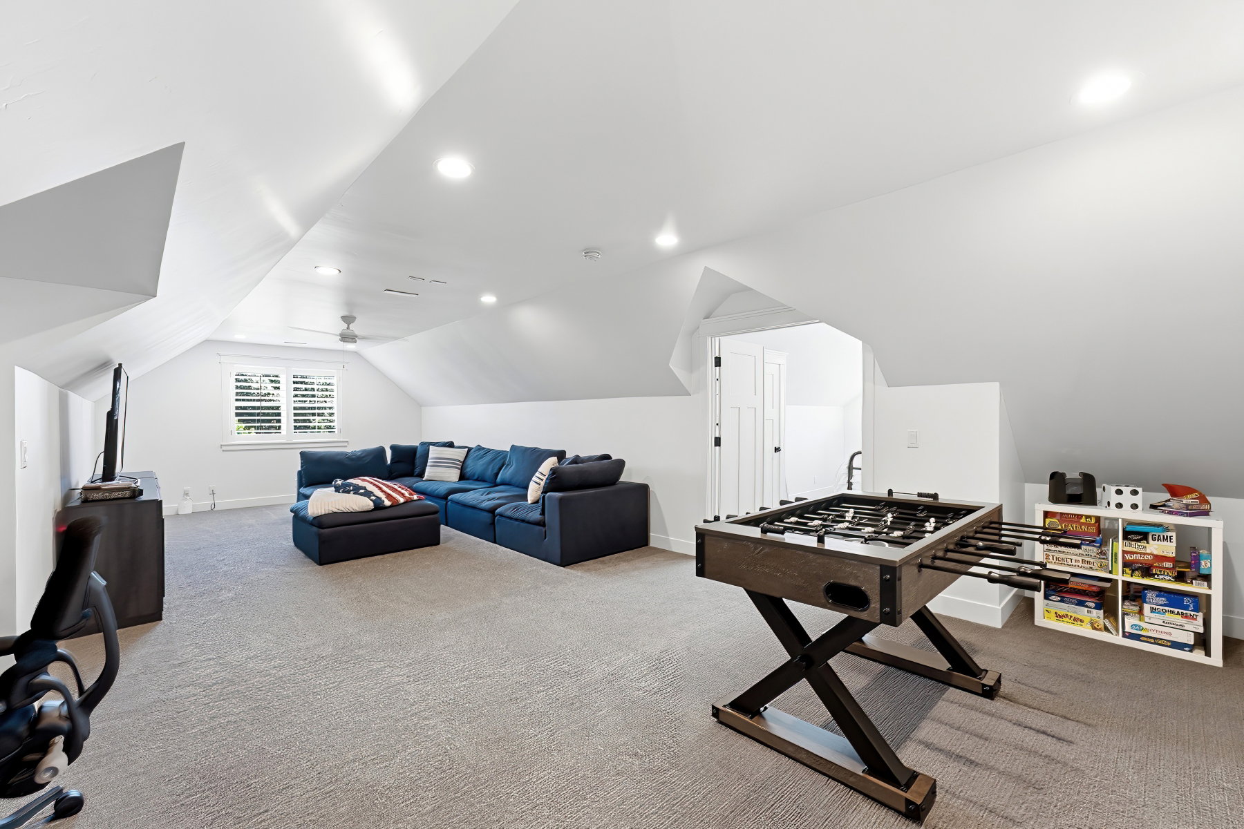 Spacious bonus room featuring vaulted ceilings, recessed lighting, carpet flooring, and a ceiling fan