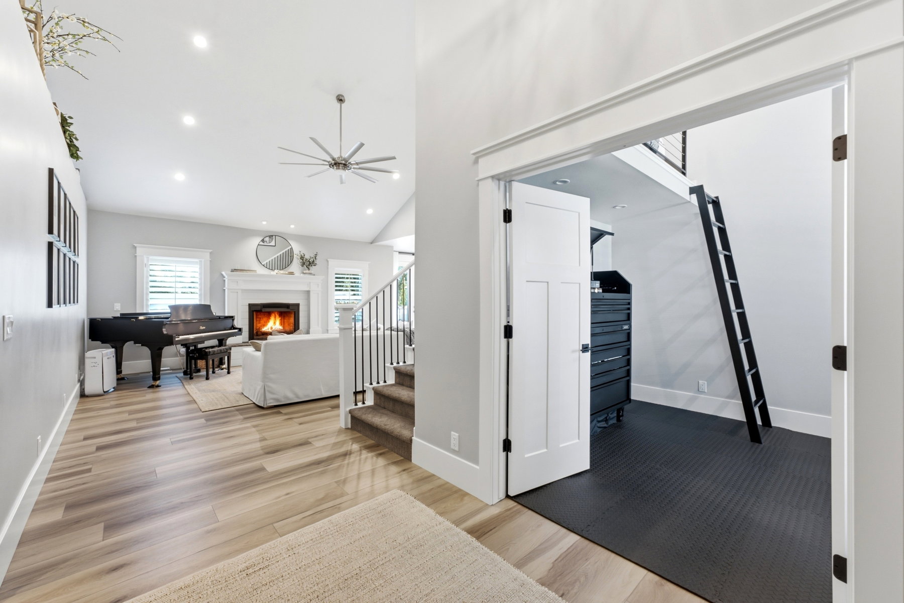 Open concept living area featuring wood-finish flooring, recessed lighting, and a vaulted ceiling