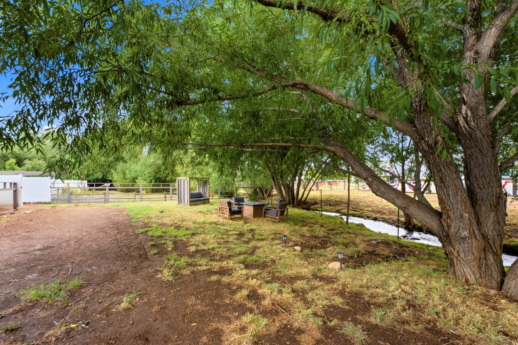 Expansive outdoor space featuring mature trees providing ample shade