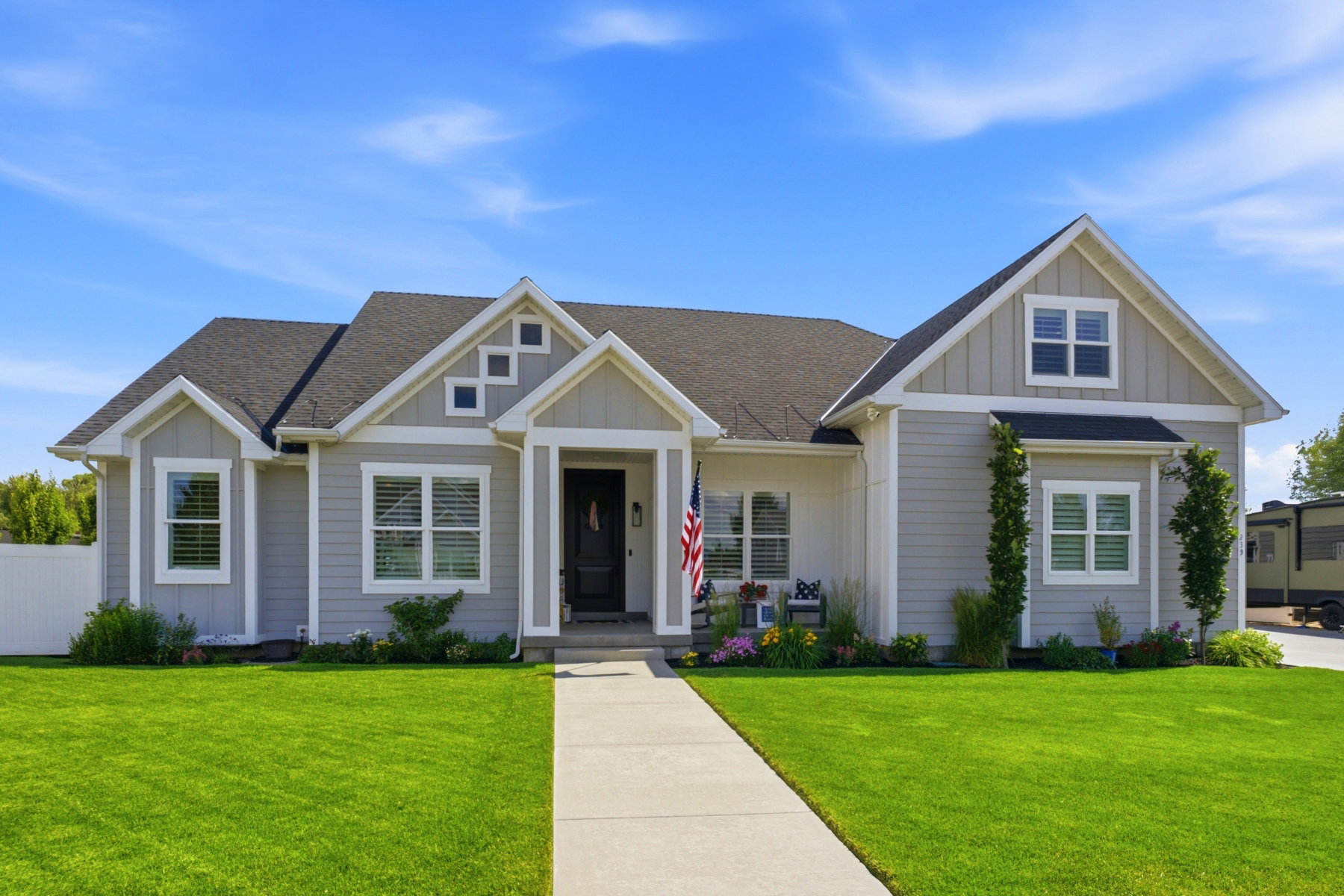 Craftsman-style exterior featuring light gray siding and white trim