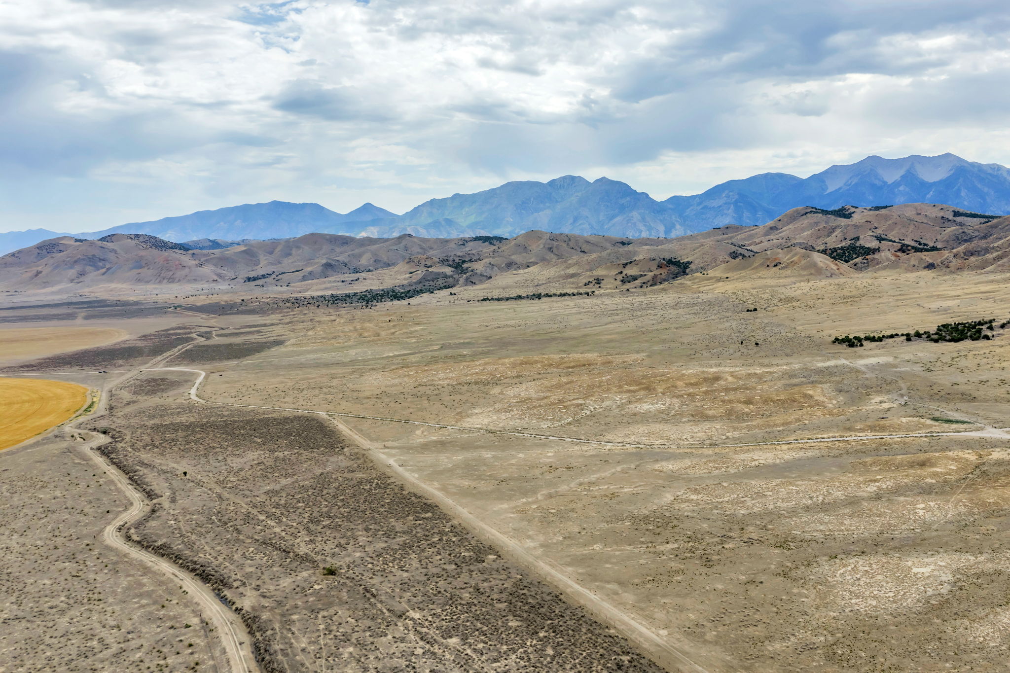 Expansive undeveloped land with a distant mountain range backdrop