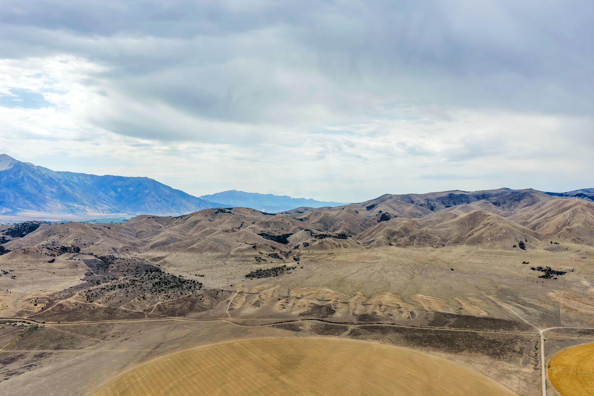Expansive undeveloped land featuring rolling hills and distant mountains