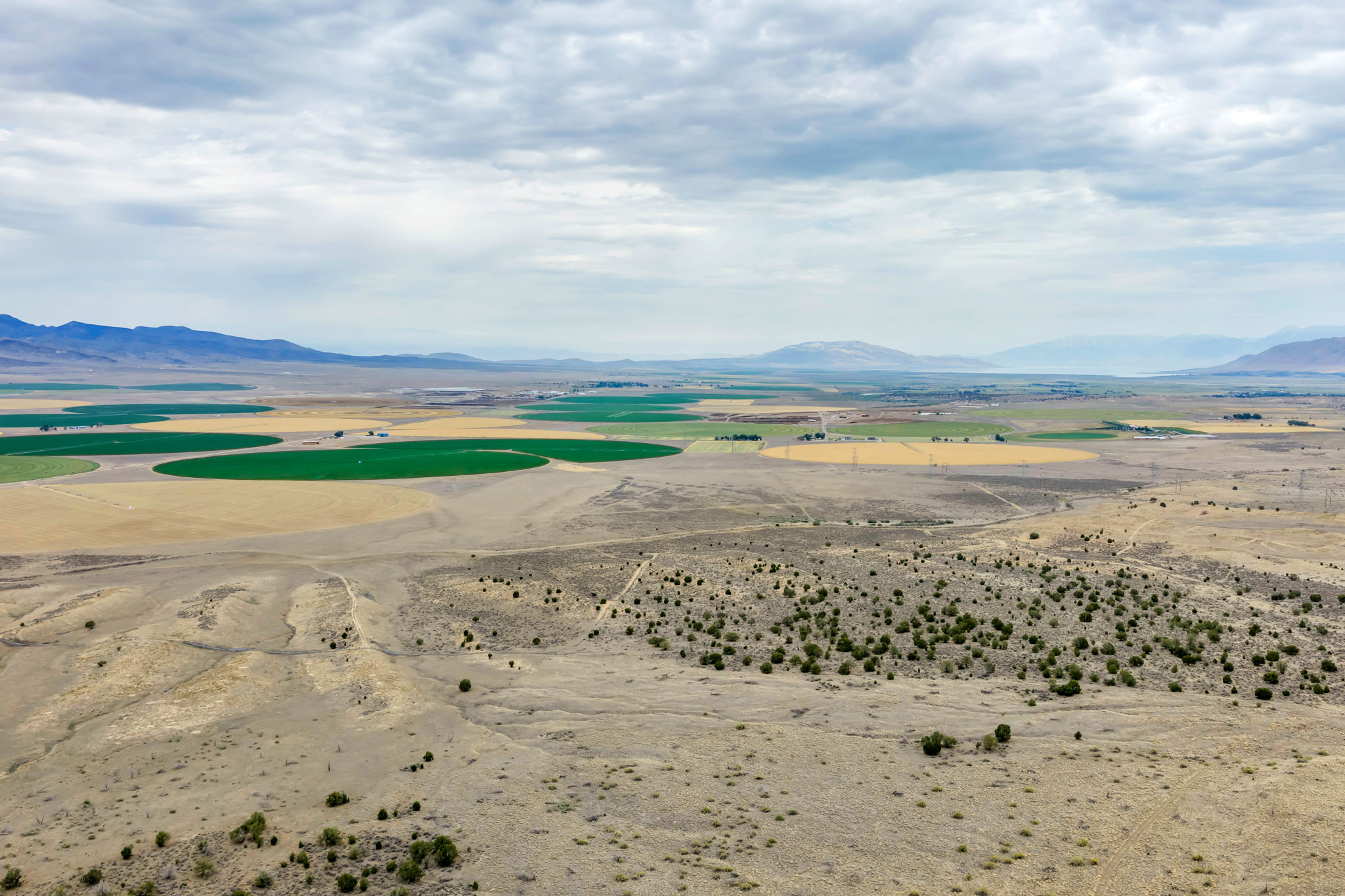 Expansive natural landscape featuring varied terrain and distant mountain ranges