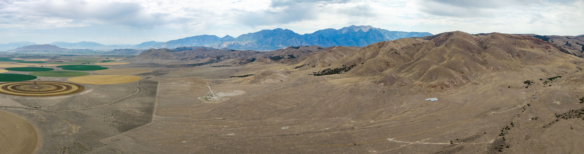 Expansive arid landscape featuring natural terrain and distant mountains