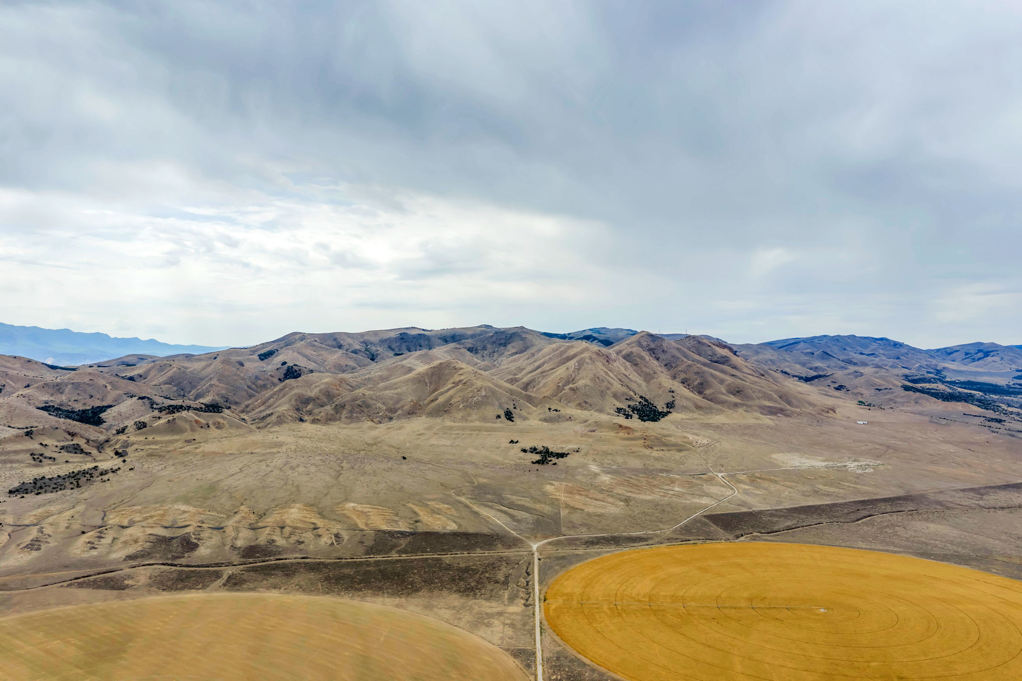 Expansive landscape featuring distant mountains and rolling hills