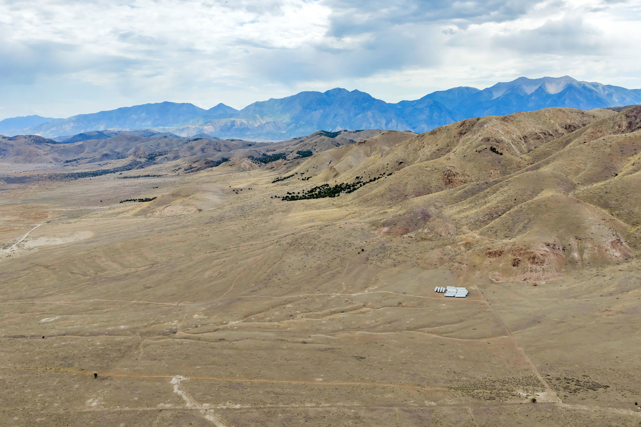 Expansive desert landscape featuring rugged terrain and distant mountain ranges