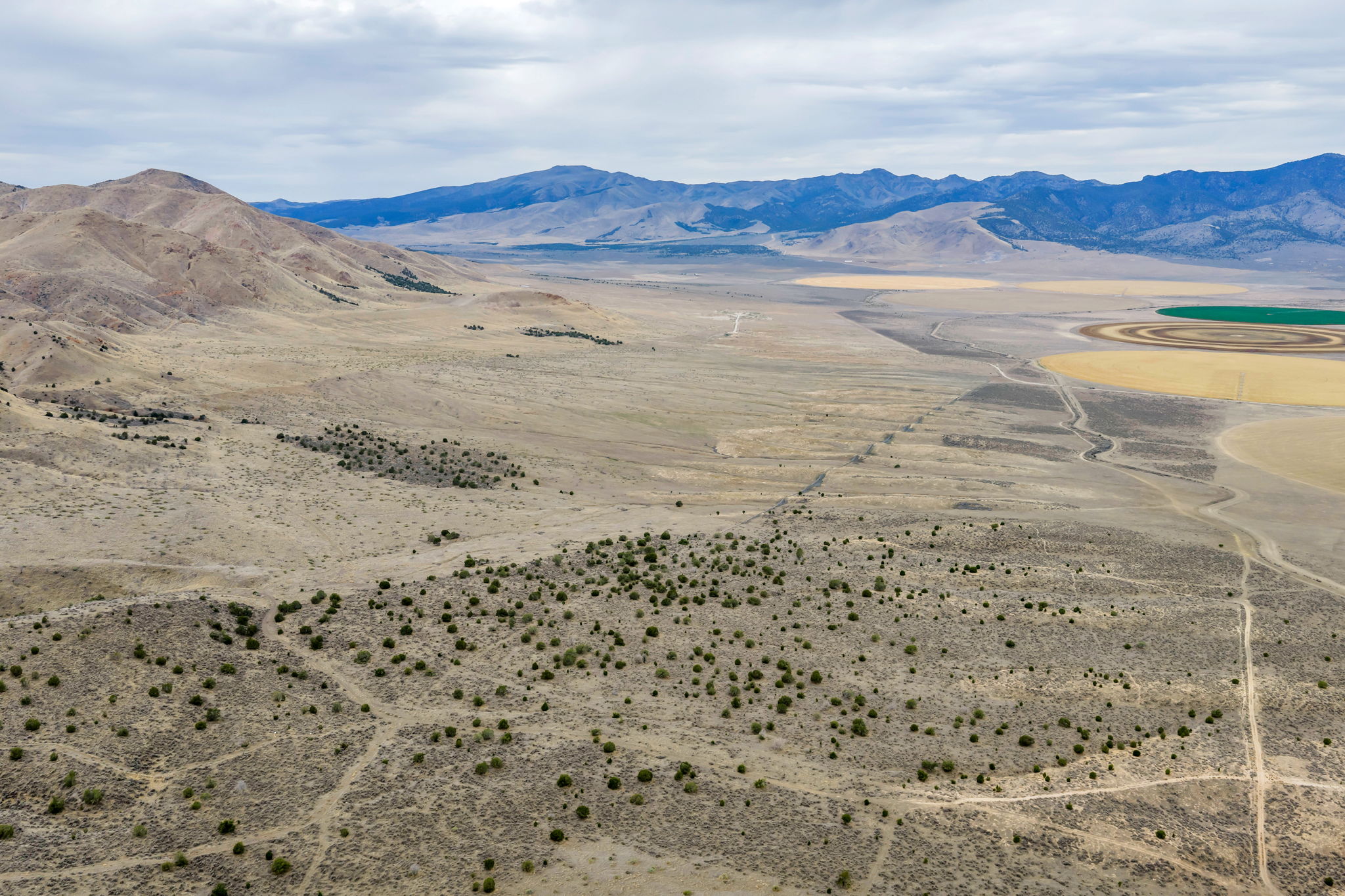 Expansive arid landscape featuring natural terrain and distant mountains