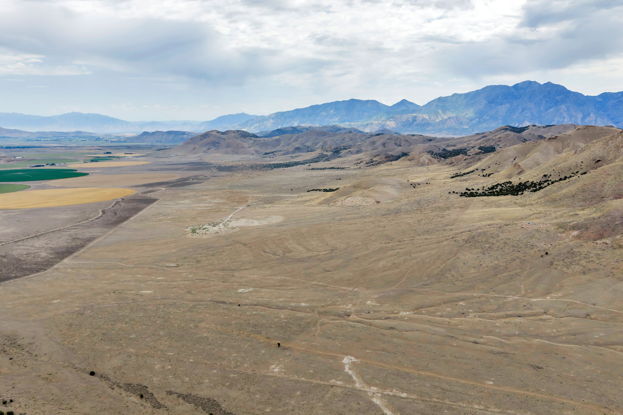 Expansive land parcel featuring natural terrain and distant mountains