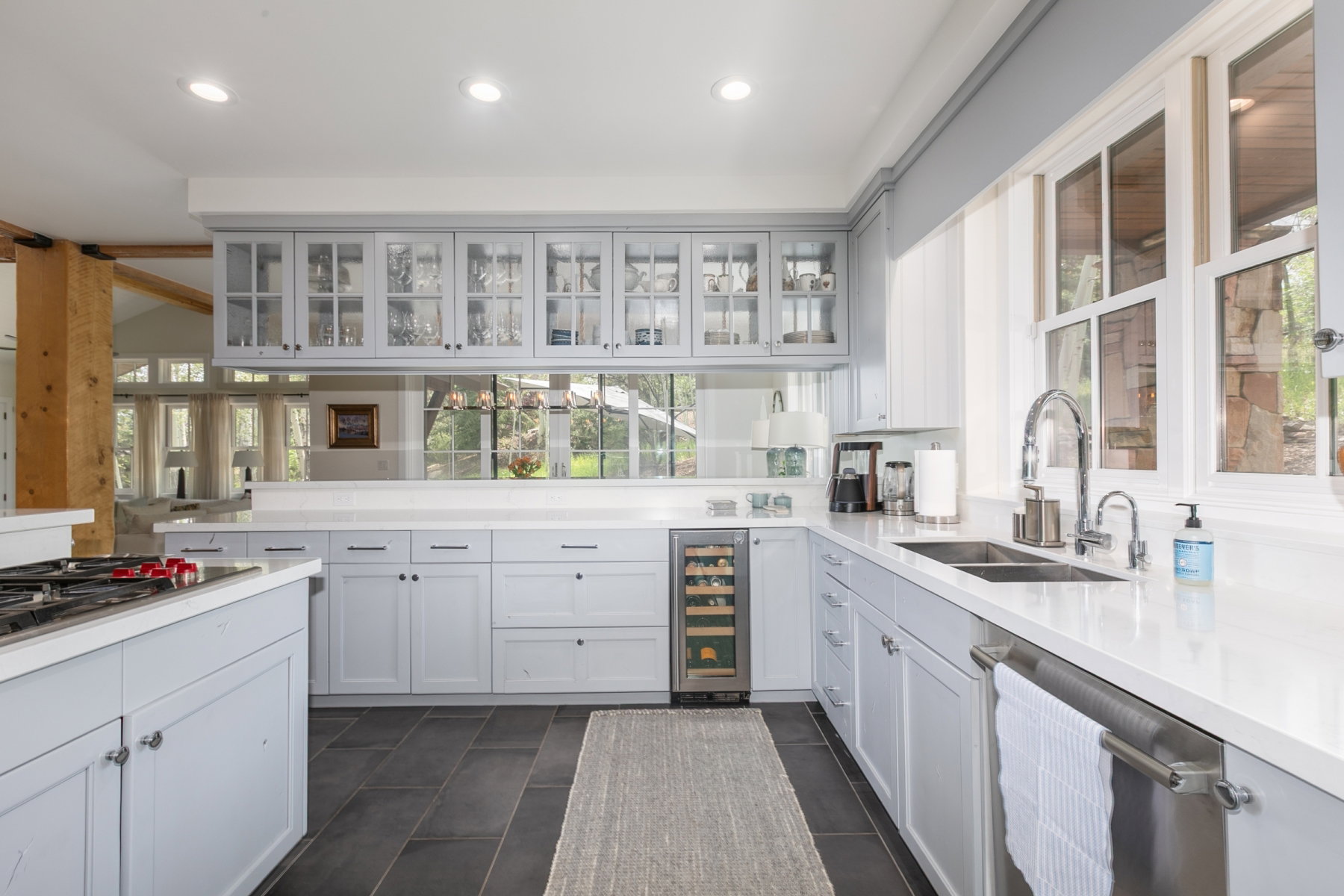 Kitchen featuring light gray cabinetry, dark tile flooring, and light-colored countertops