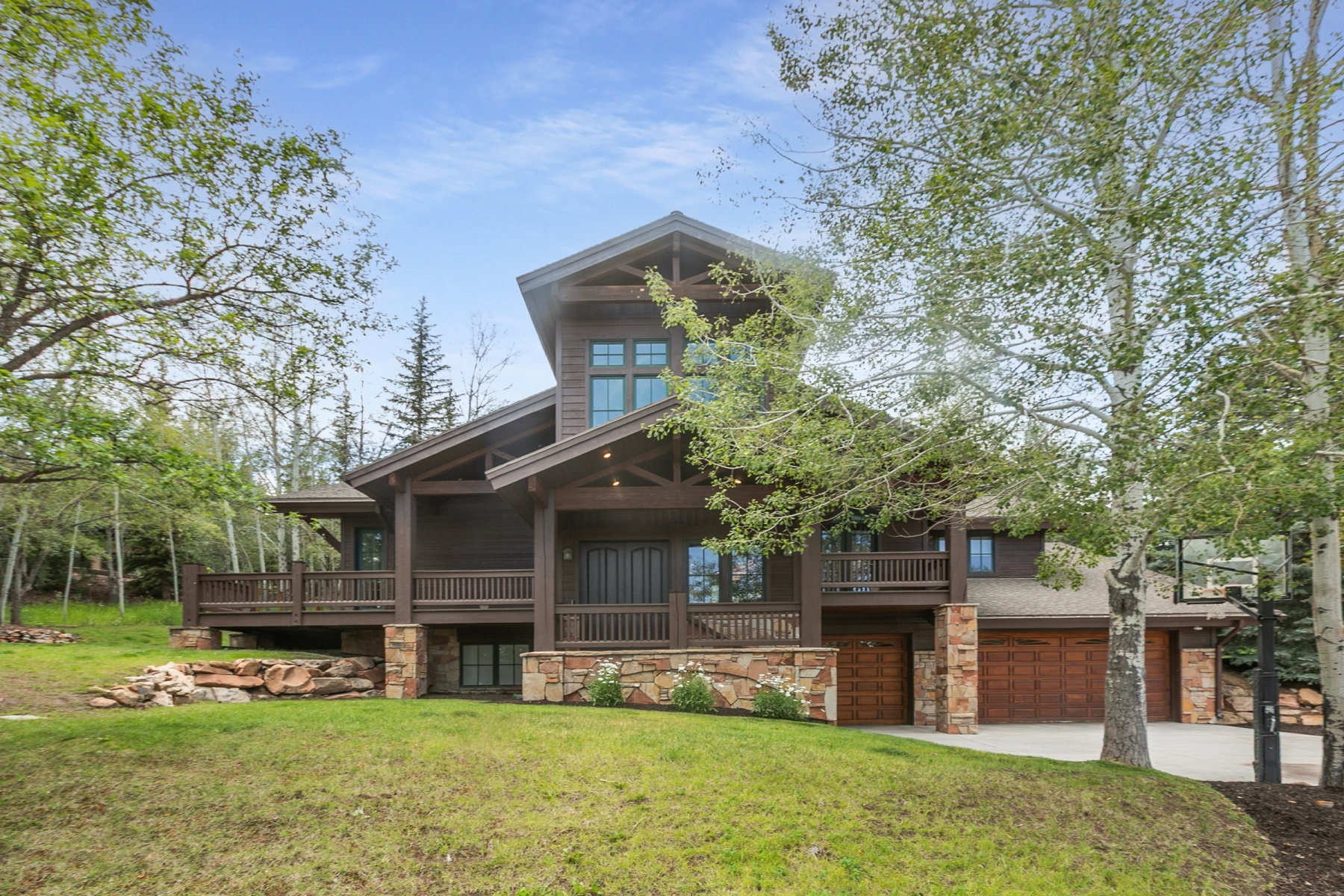 Multi-level contemporary residence featuring rich wood siding and stone accents