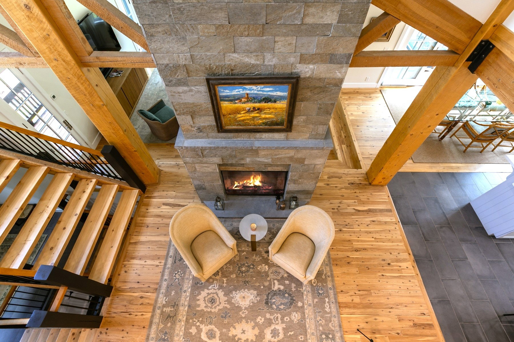 Floor-to-ceiling stone fireplace featuring a hearth