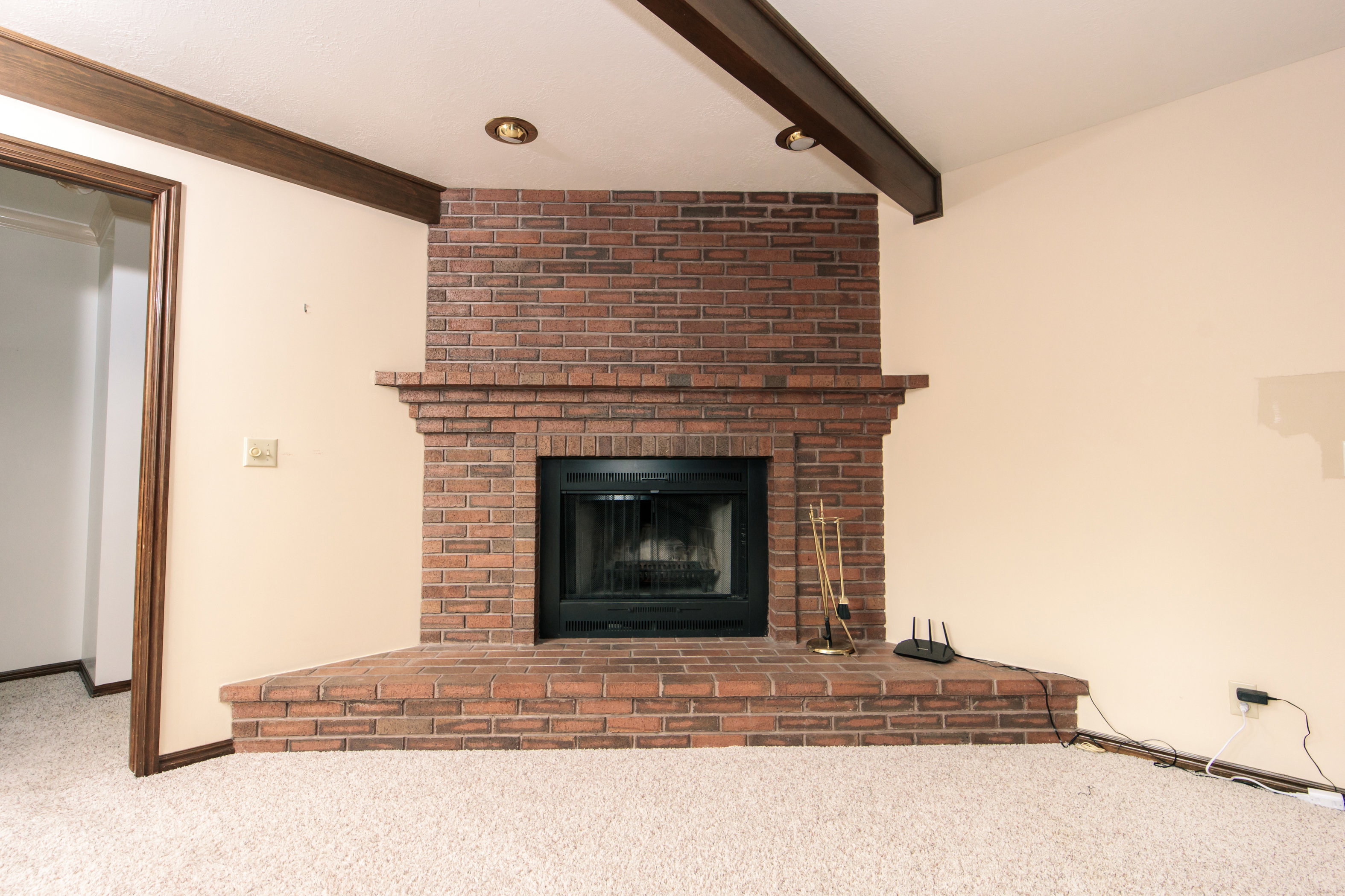 Brick fireplace with a black firebox and a wide, raised hearth