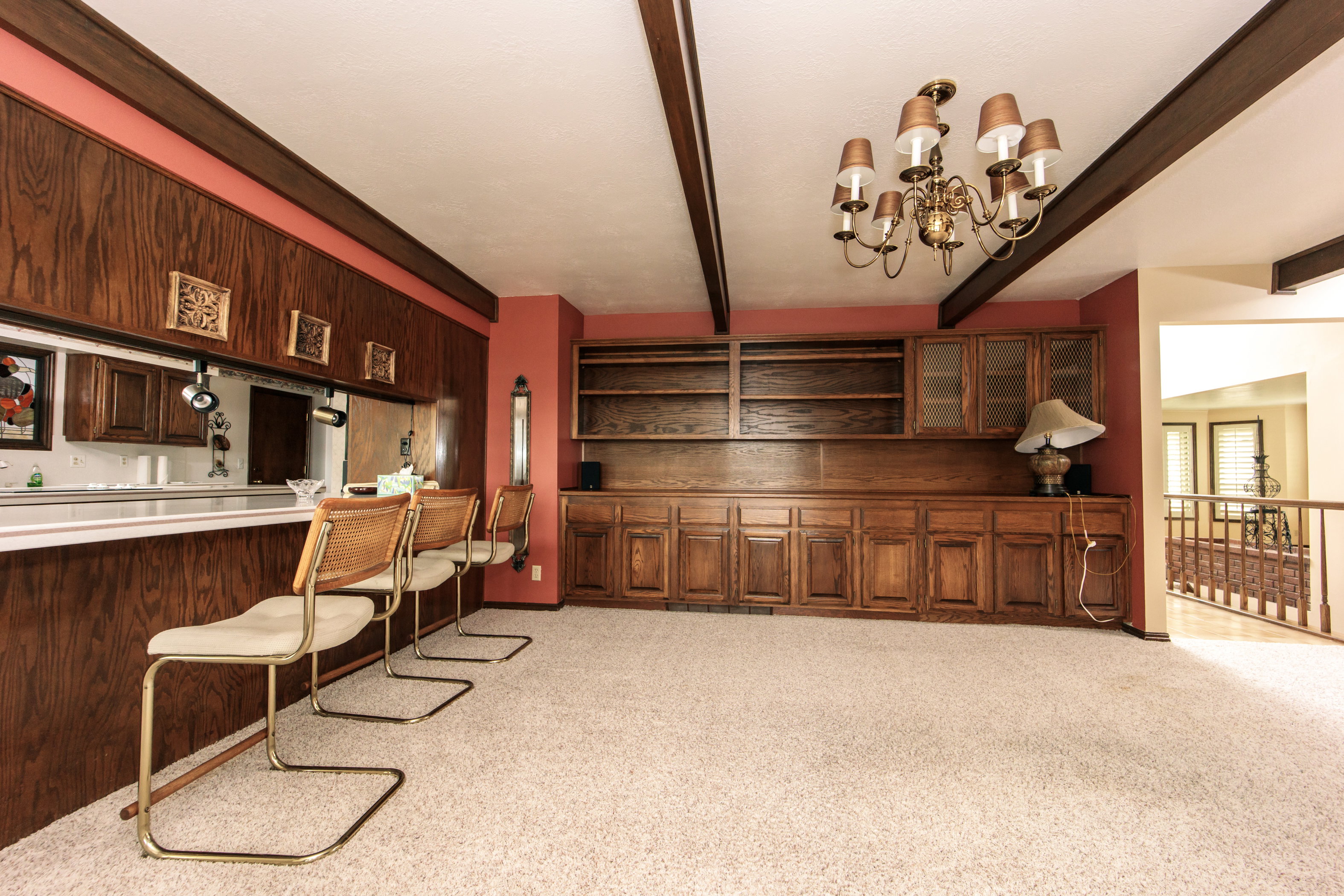 Wood-paneled bar with a white countertop and pass-through window