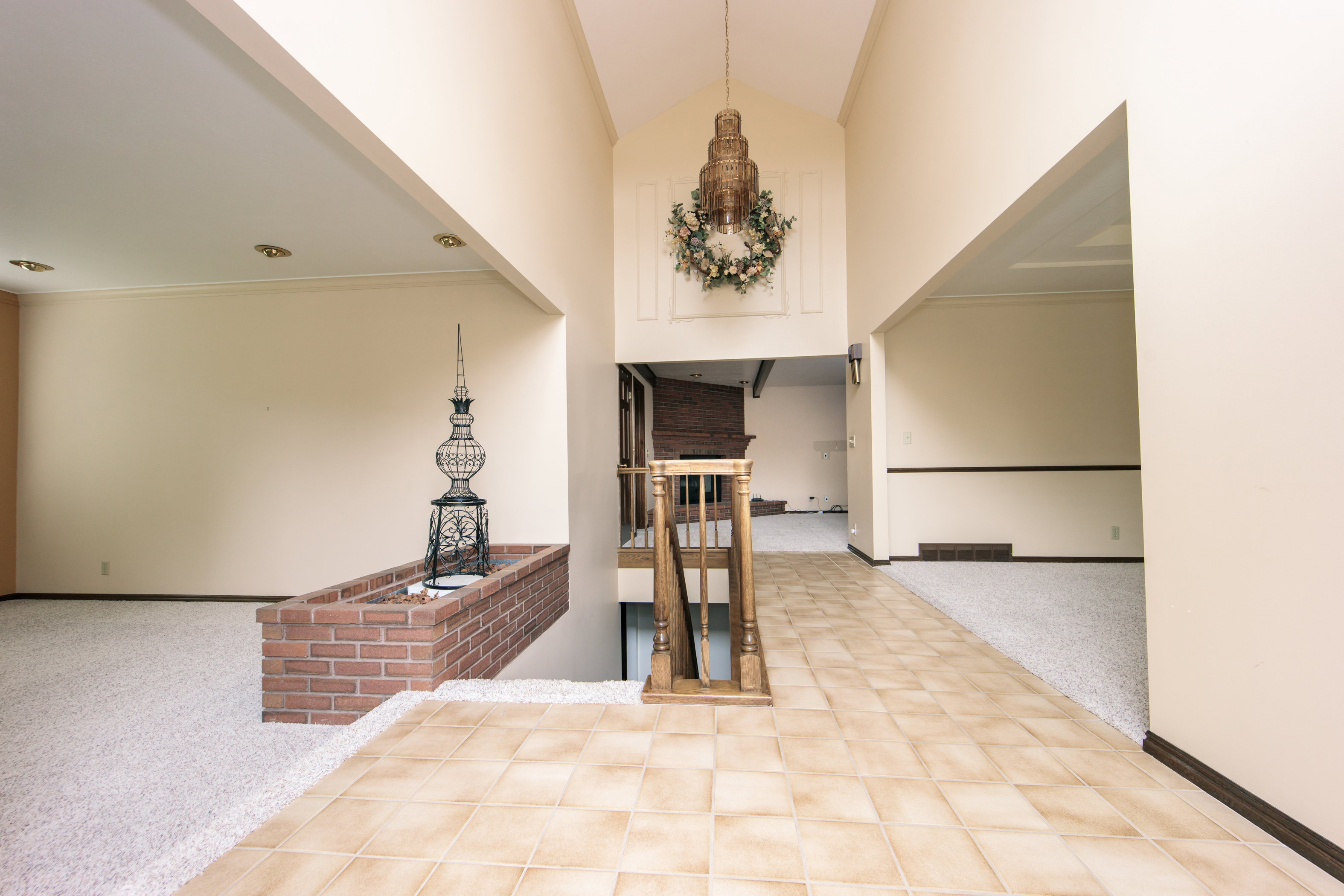 Grand entry foyer featuring a vaulted ceiling and an impressive chandelier