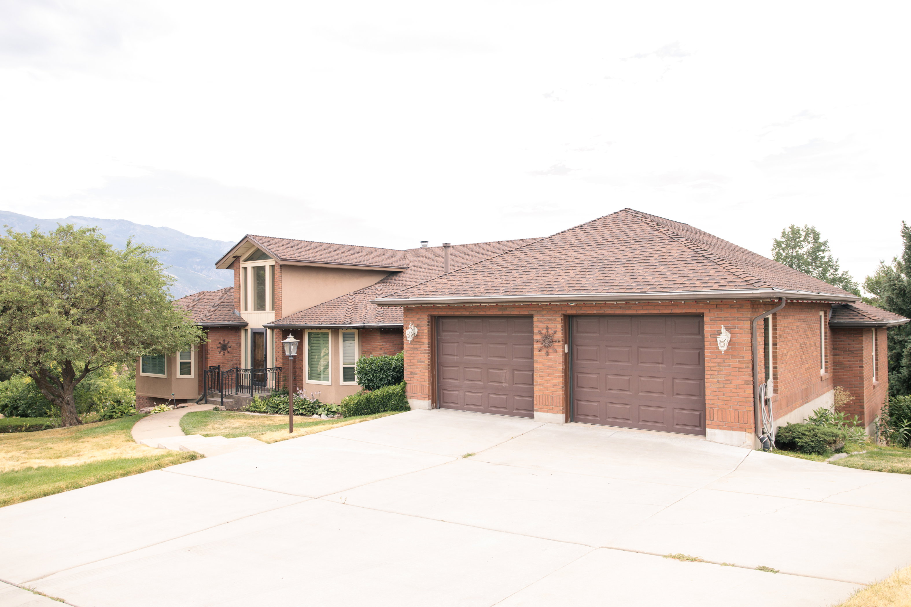 Brick and stucco exterior with a prominent two-car garage