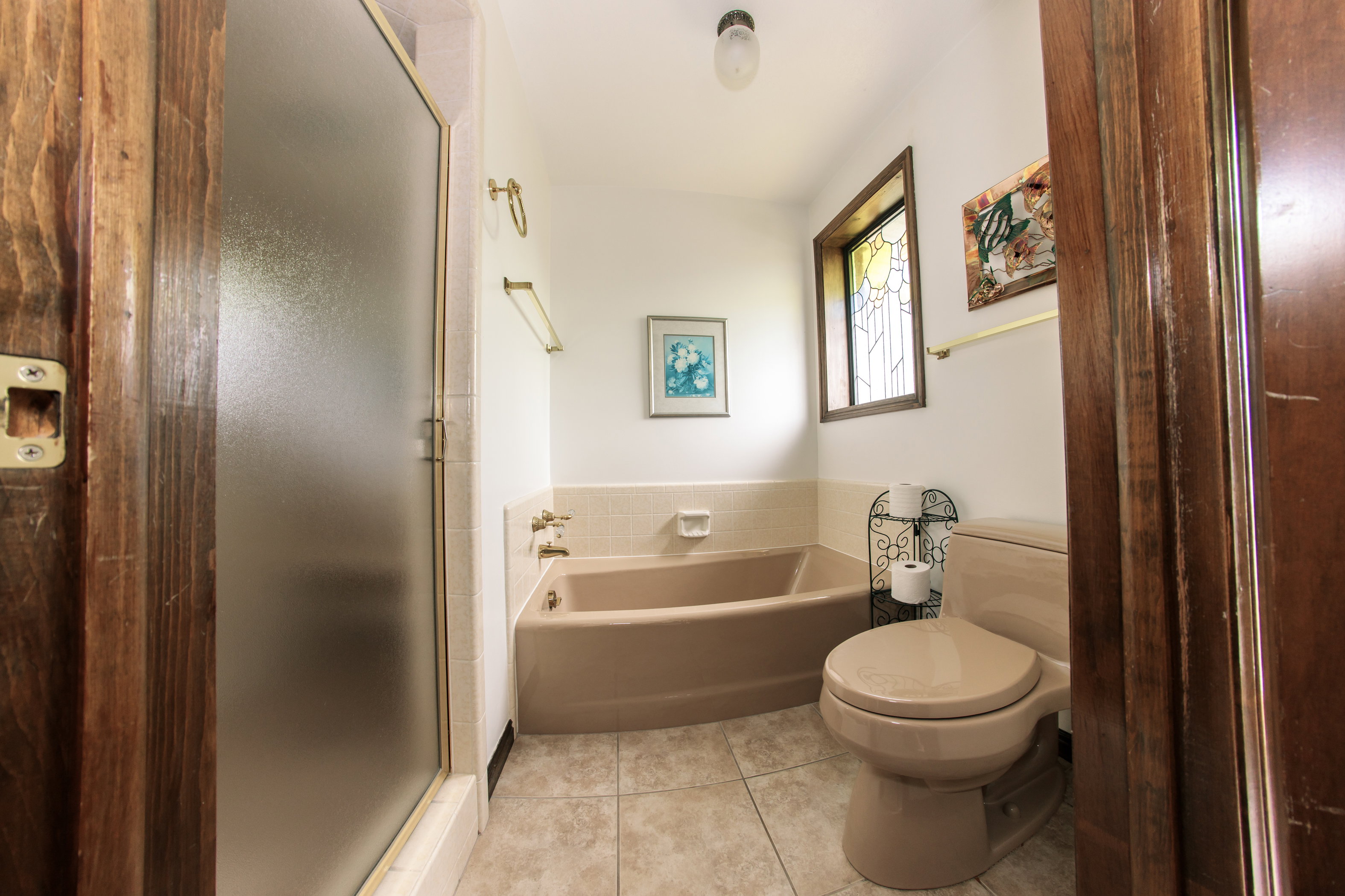 Bathroom featuring a built-in tub and toilet