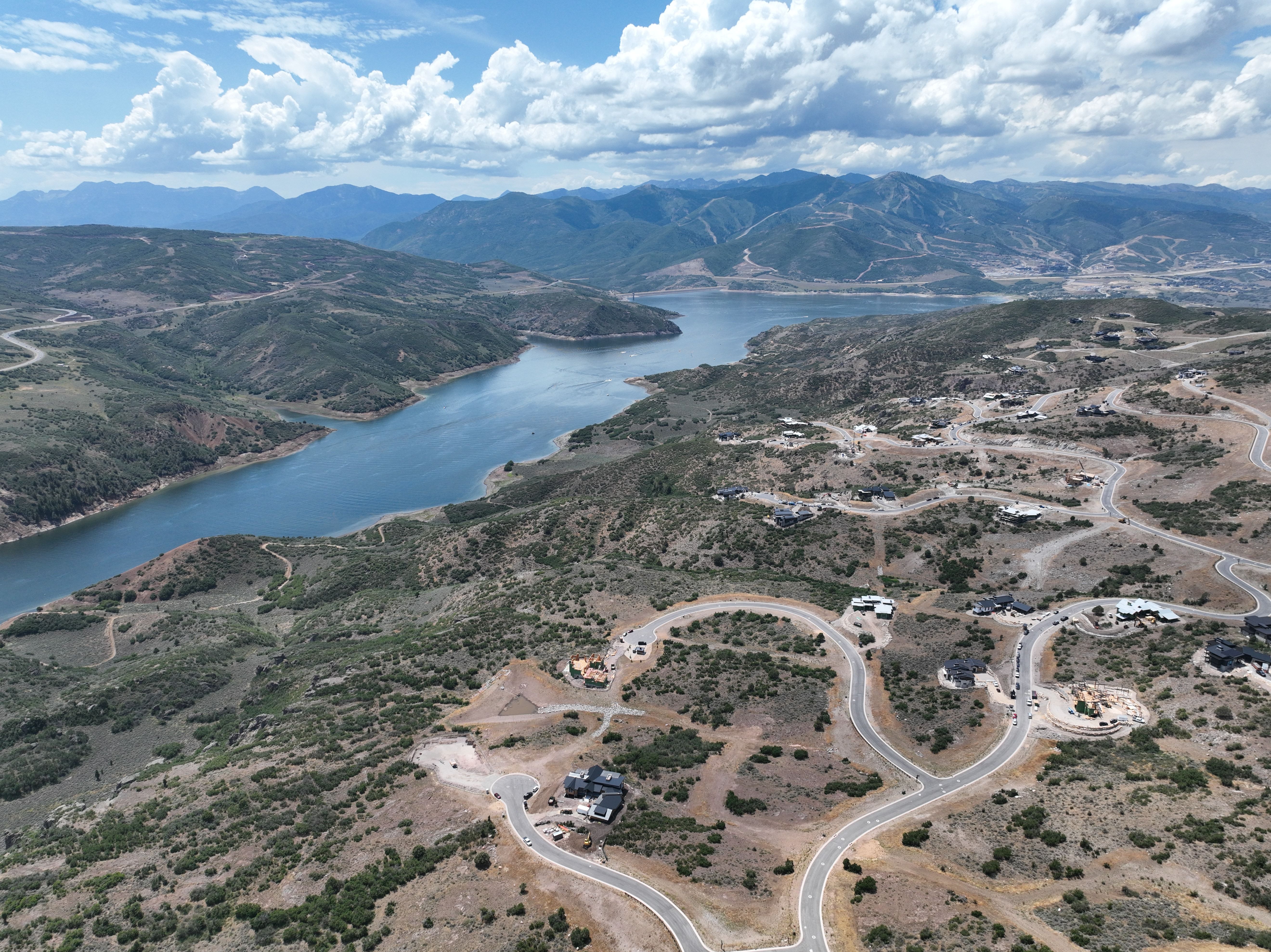 Expansive aerial showcasing a significant body of water bordered by mountainous terrain