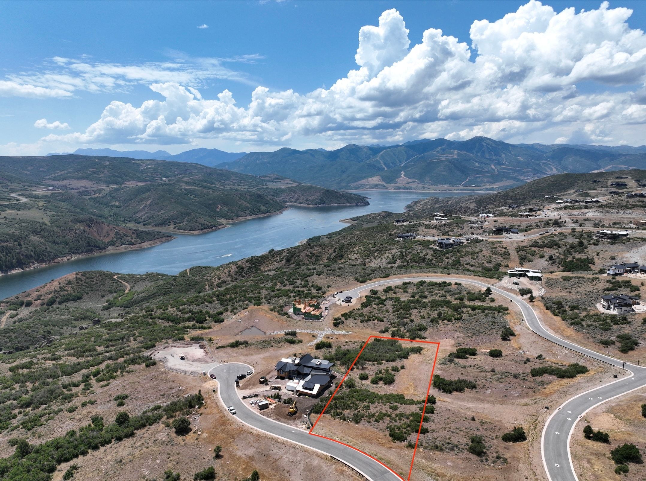 Expansive land parcel featuring natural terrain and surrounding mountainous landscape