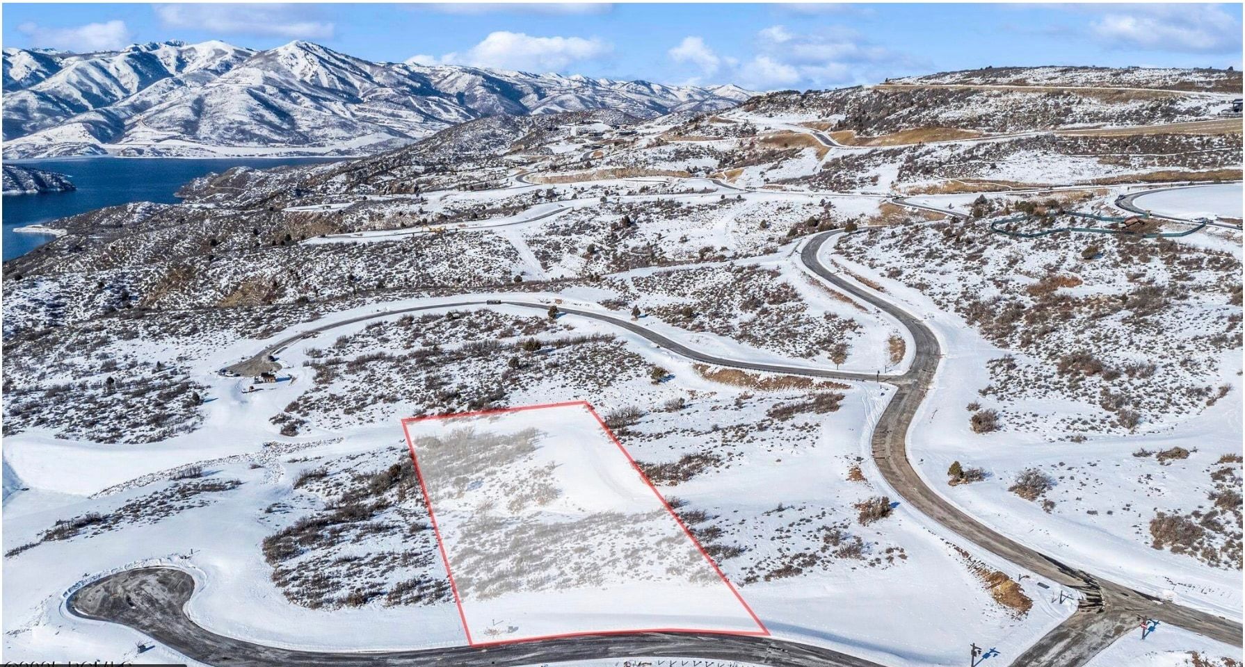 Expansive snow-covered lot featuring a clear boundary outline