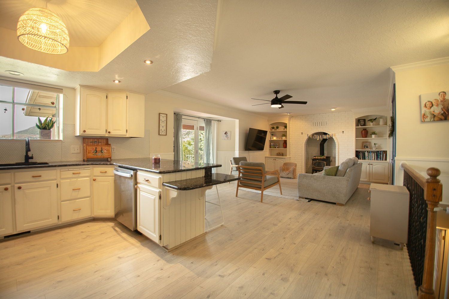 Open-concept living space with light wood-finish flooring