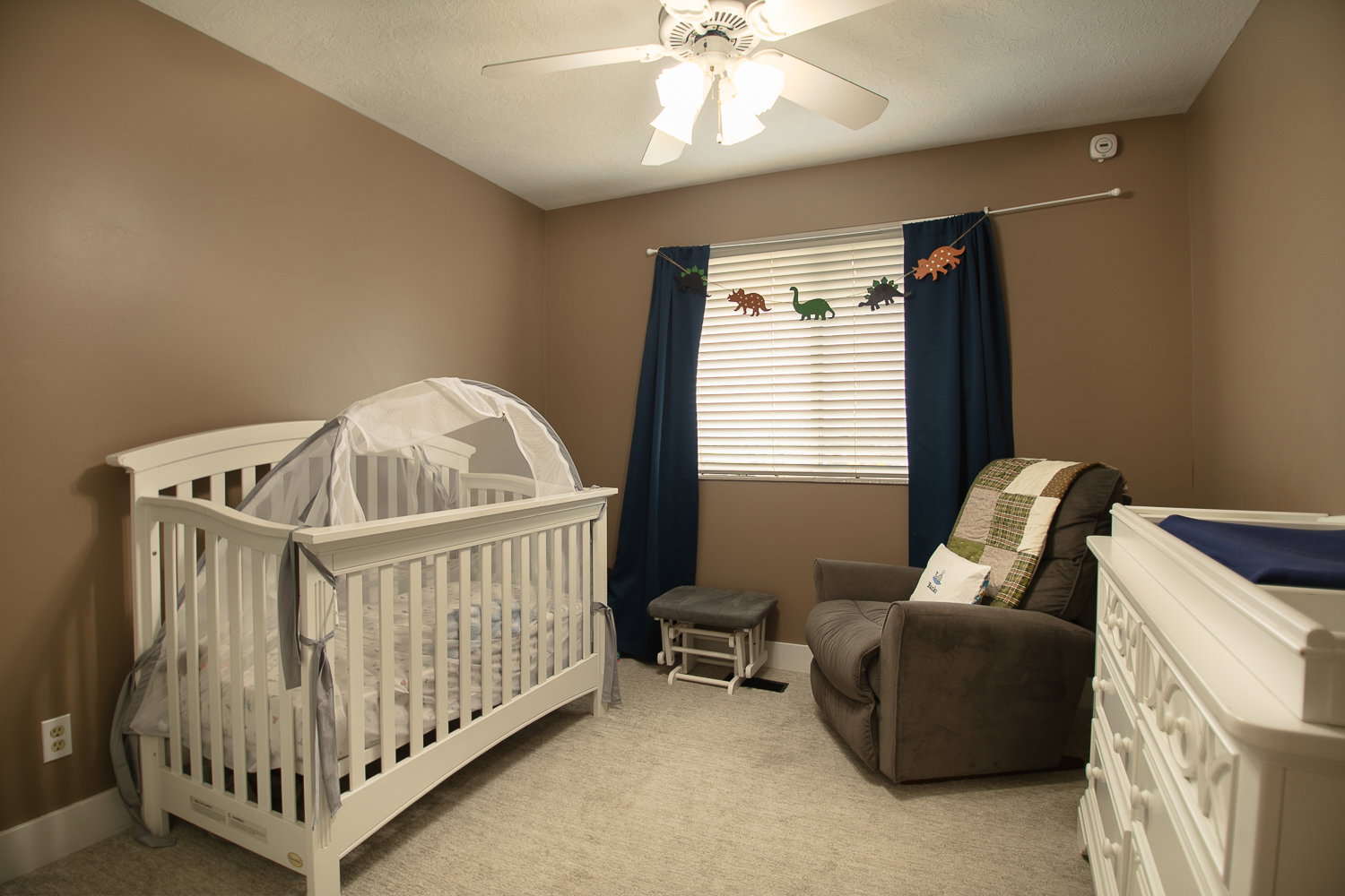 Carpeted room with a ceiling fan, window blinds, and neutral wall tones