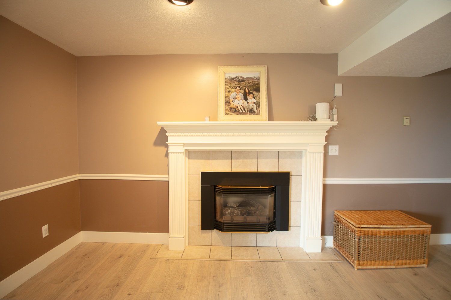 Fireplace with a white mantel and tile surround