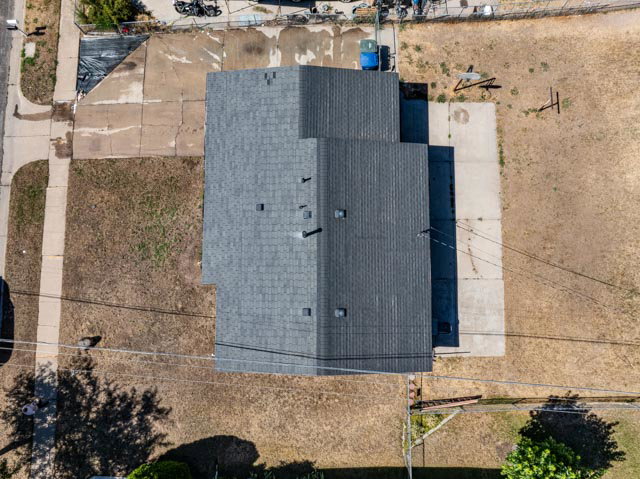 Asphalt shingle roof with multiple vents and chimneys