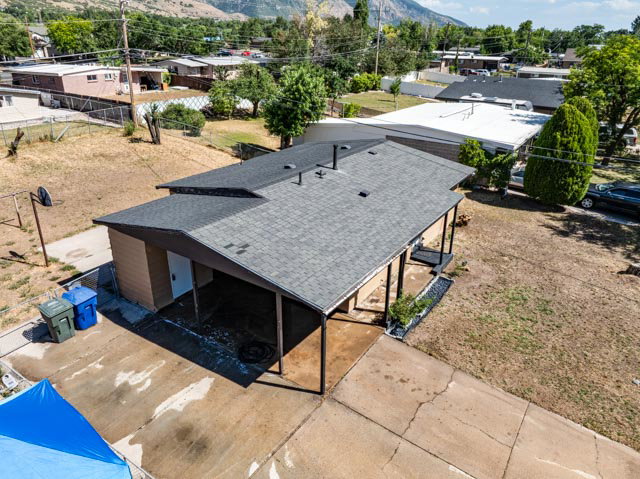 Low-slope roofline featuring asphalt shingles