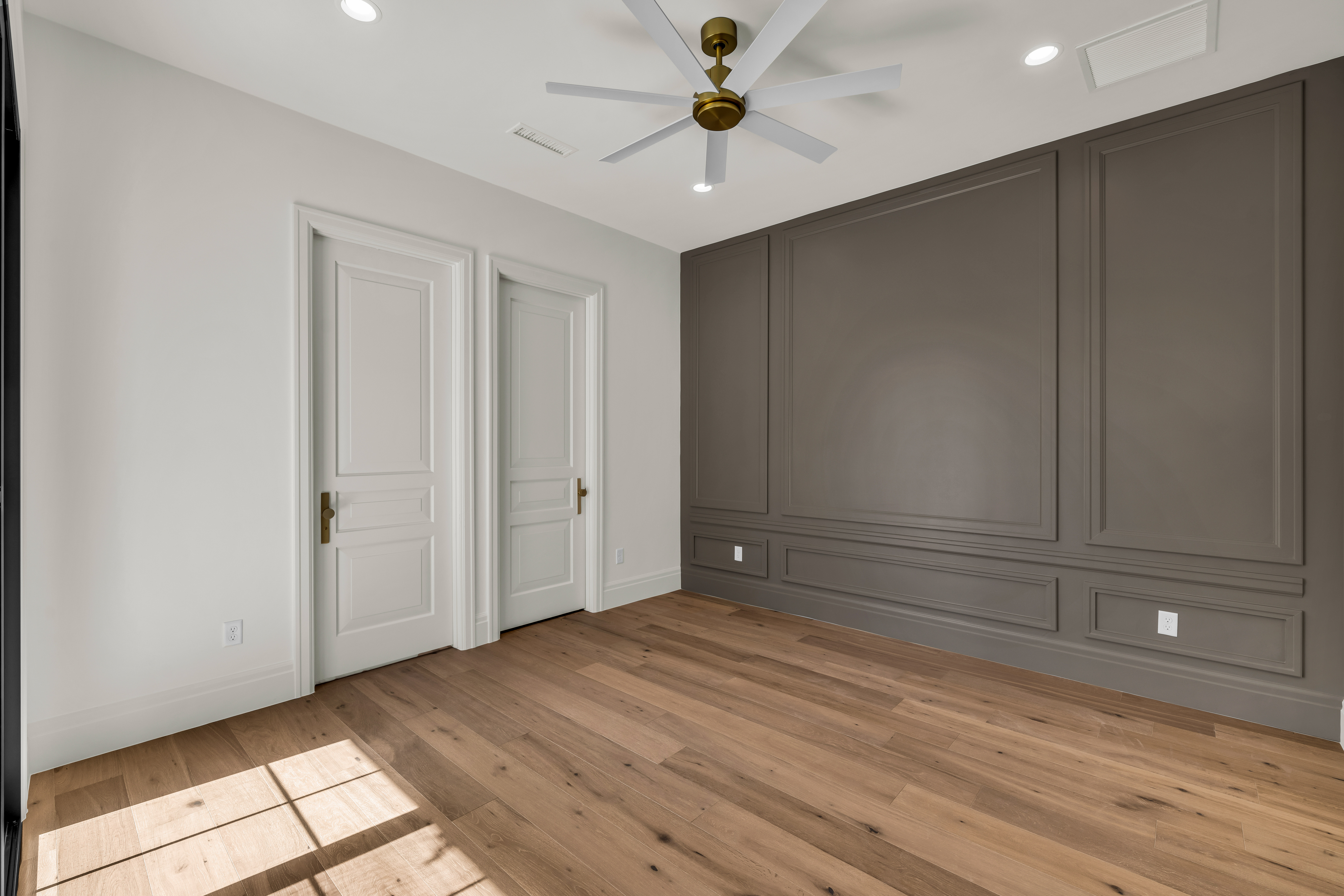 Wood-finish flooring with a multi-tone panel accent wall