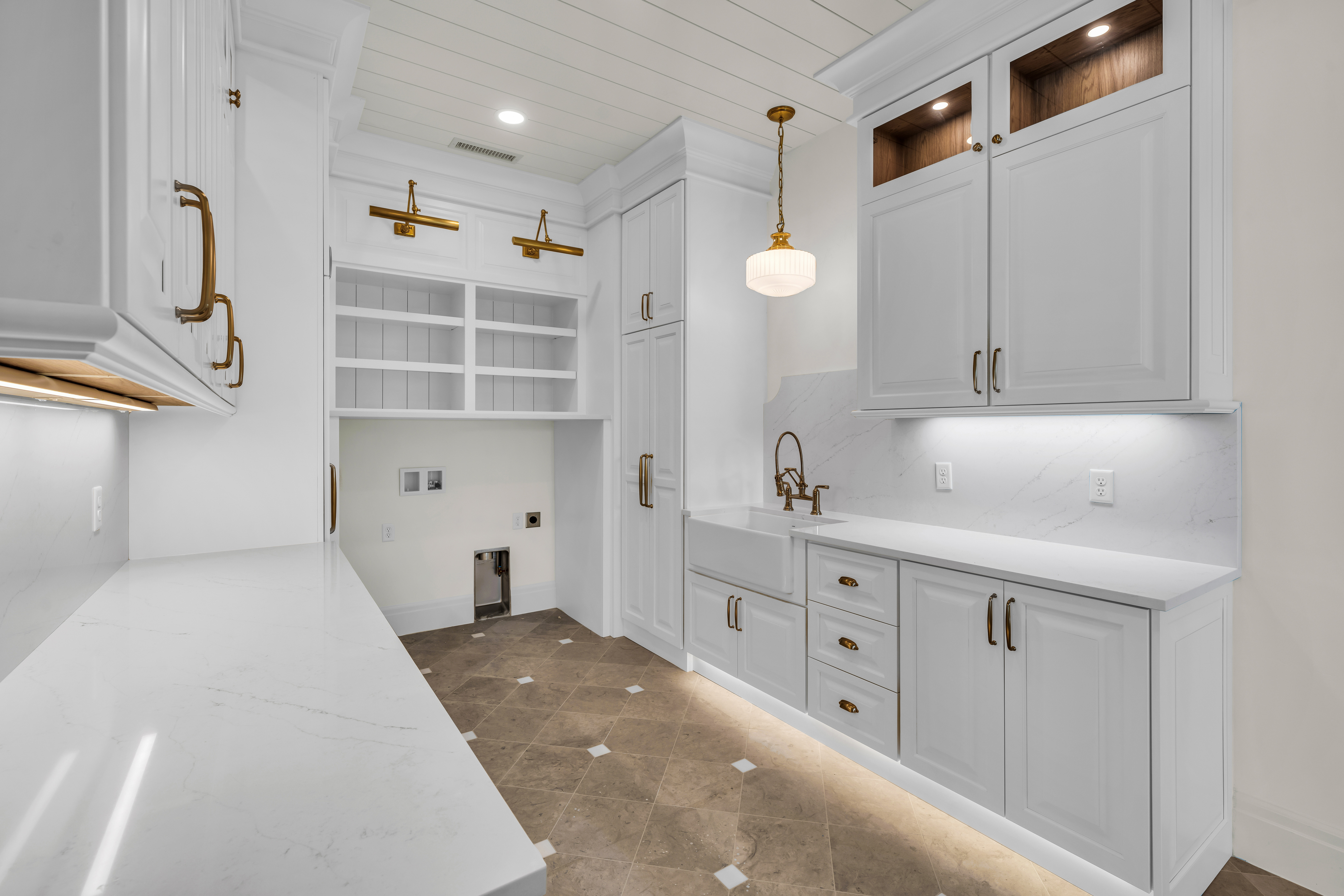 Utility room featuring white cabinetry, quartz countertops, a farmhouse sink, and under-cabinet lighting