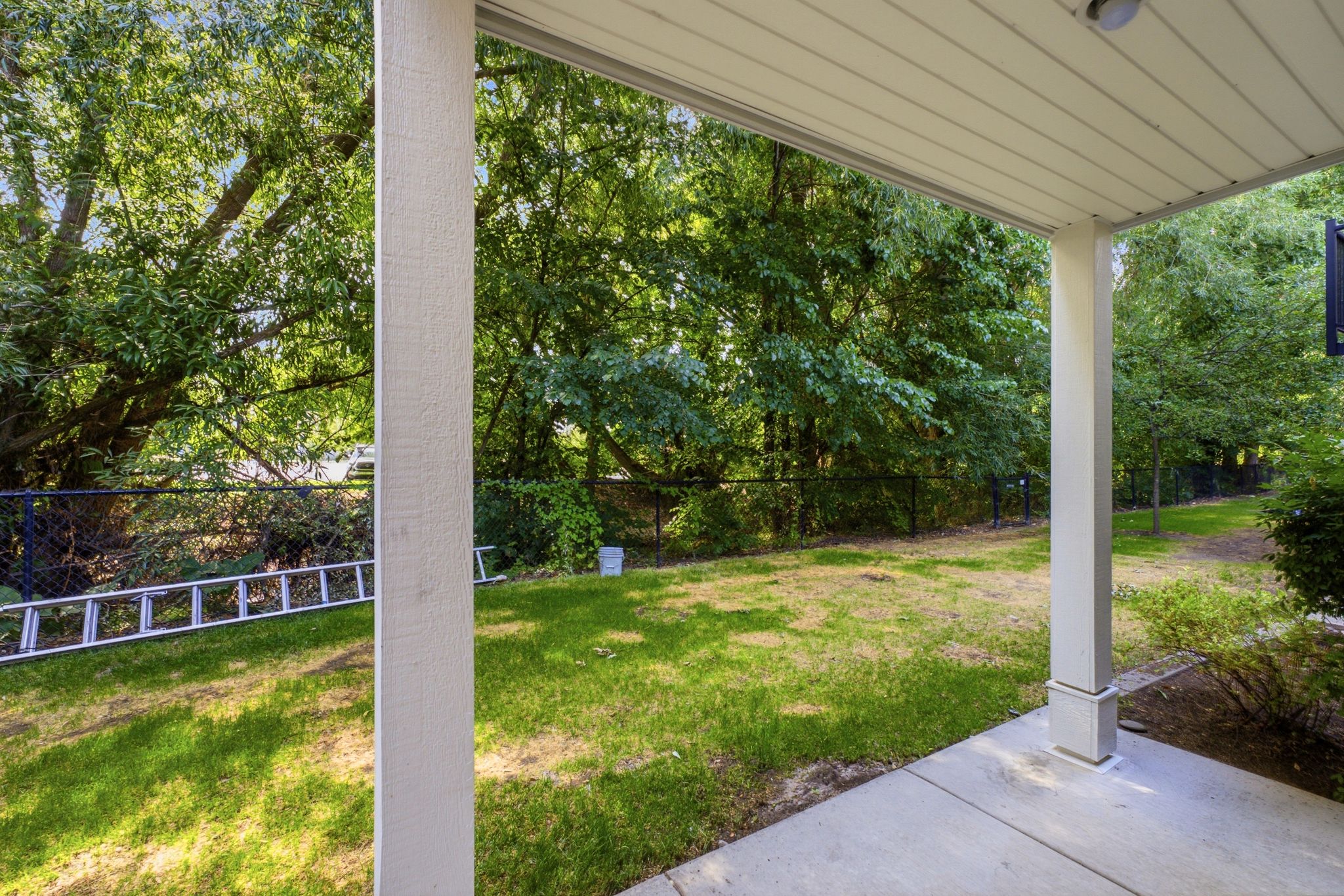 Covered patio featuring a concrete surface and white support columns