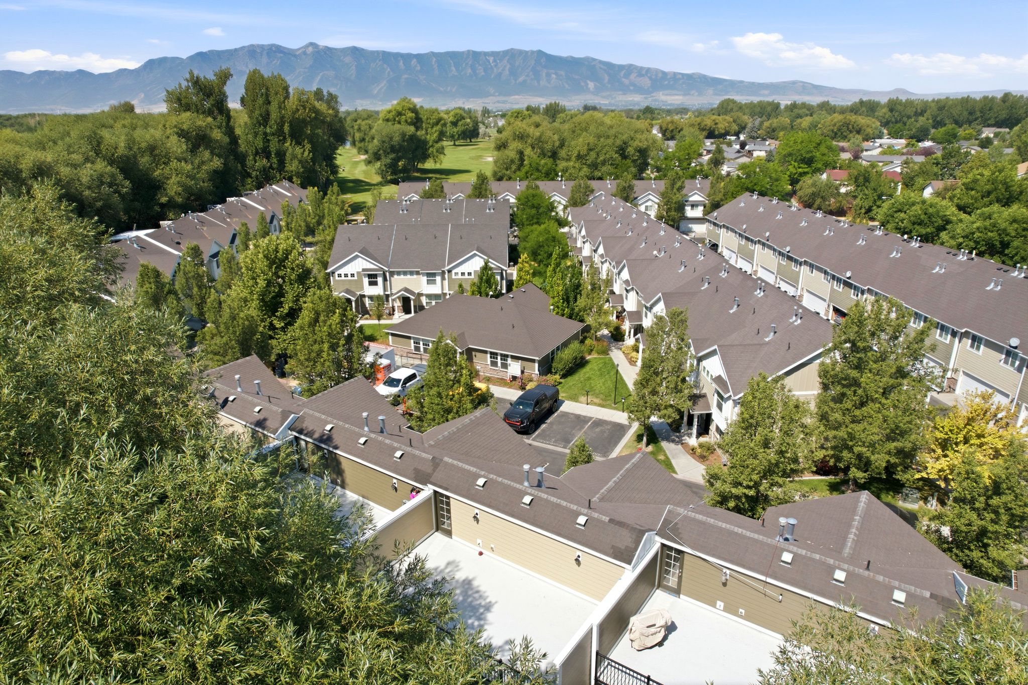 Townhome community with varied architectural facades under a clear sky