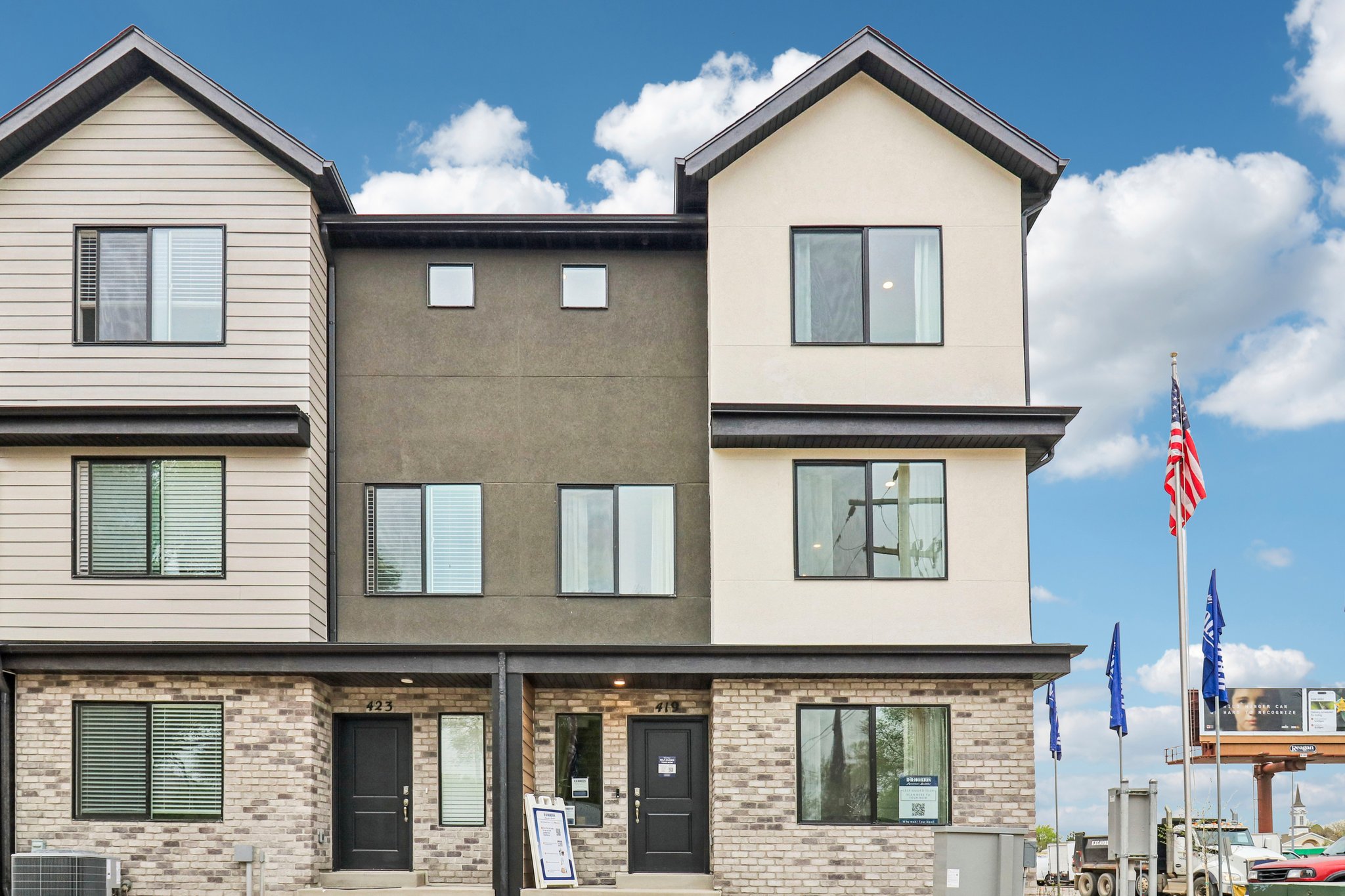 Contemporary townhome-style residences featuring a multi-textured facade