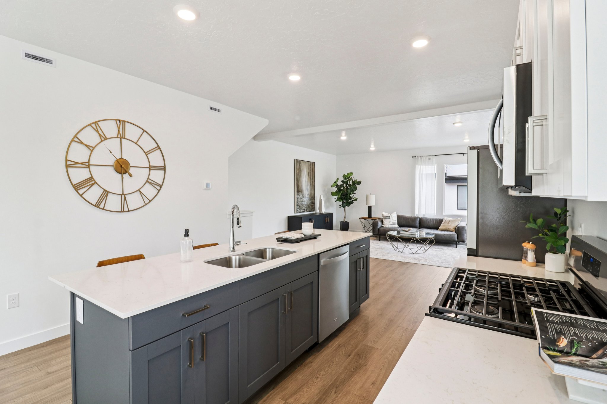Kitchen island with a light-toned countertop and dark gray cabinetry
