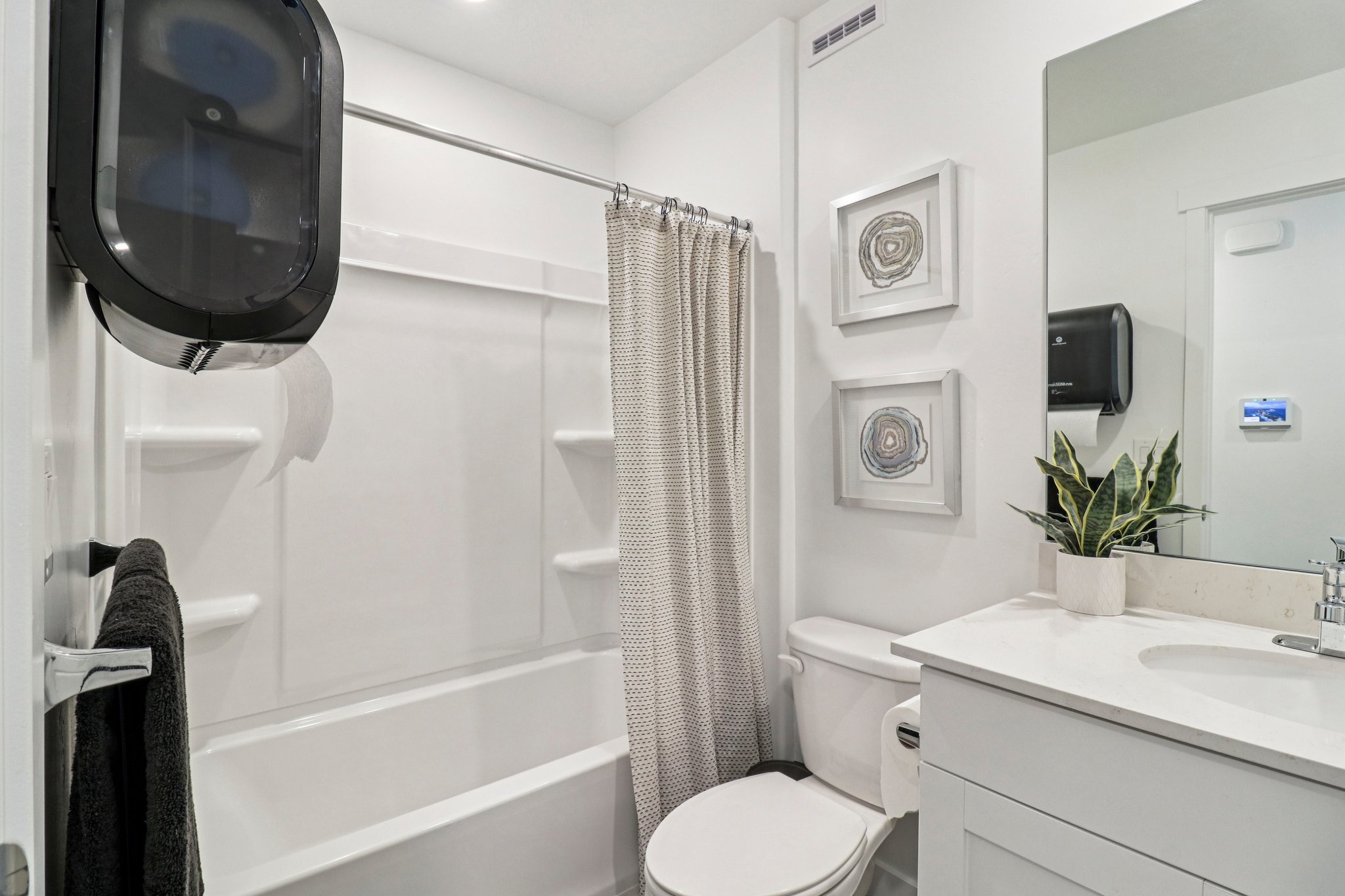 Bathroom featuring a white vanity with an integrated sink and light-colored countertop