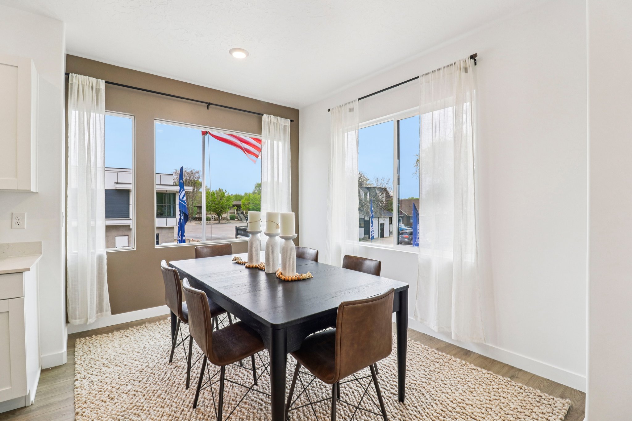Dining area featuring a contemporary dark wood-finish table with seating for six