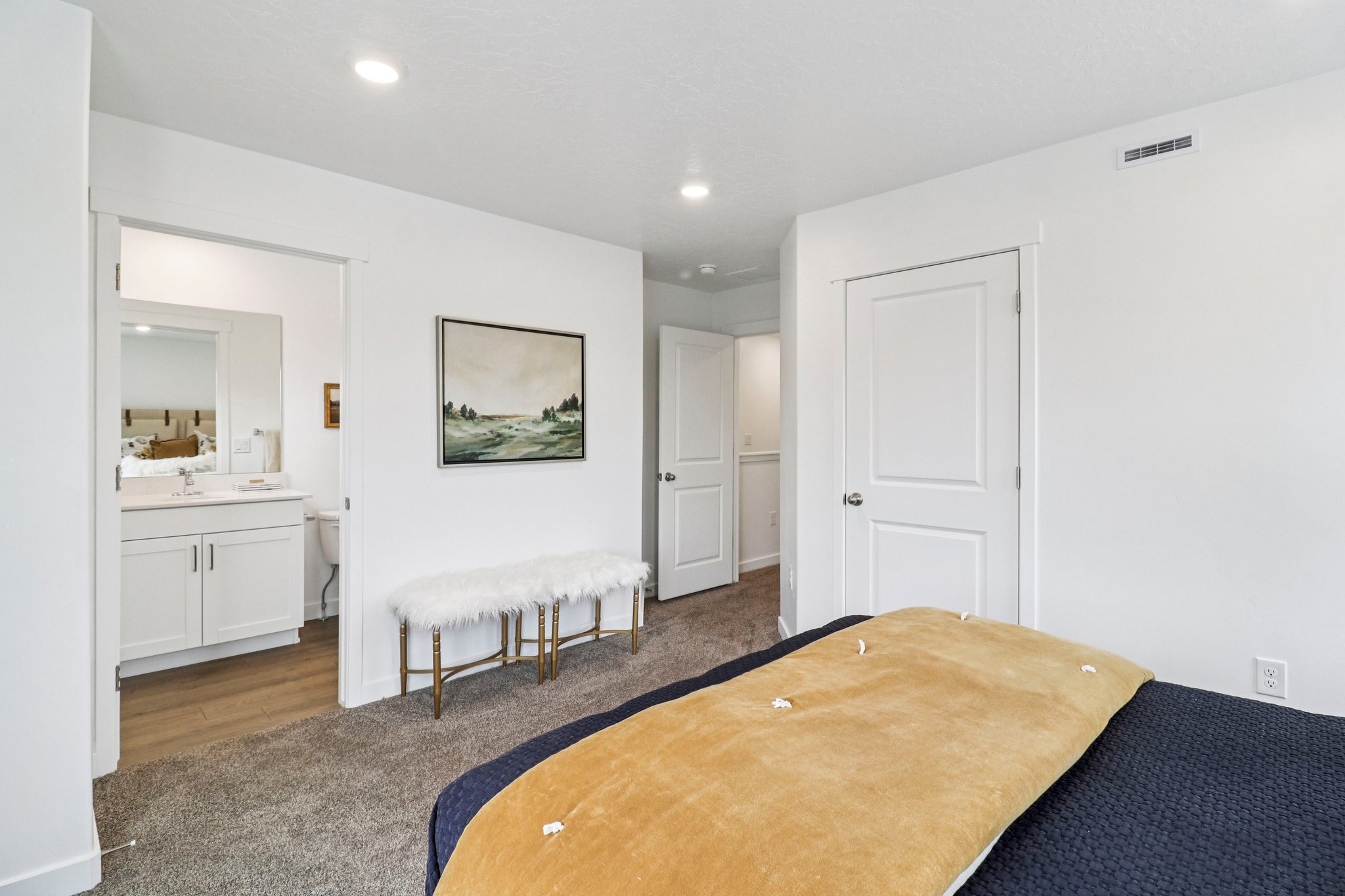 Carpeted room with recessed lighting and a white paneled door