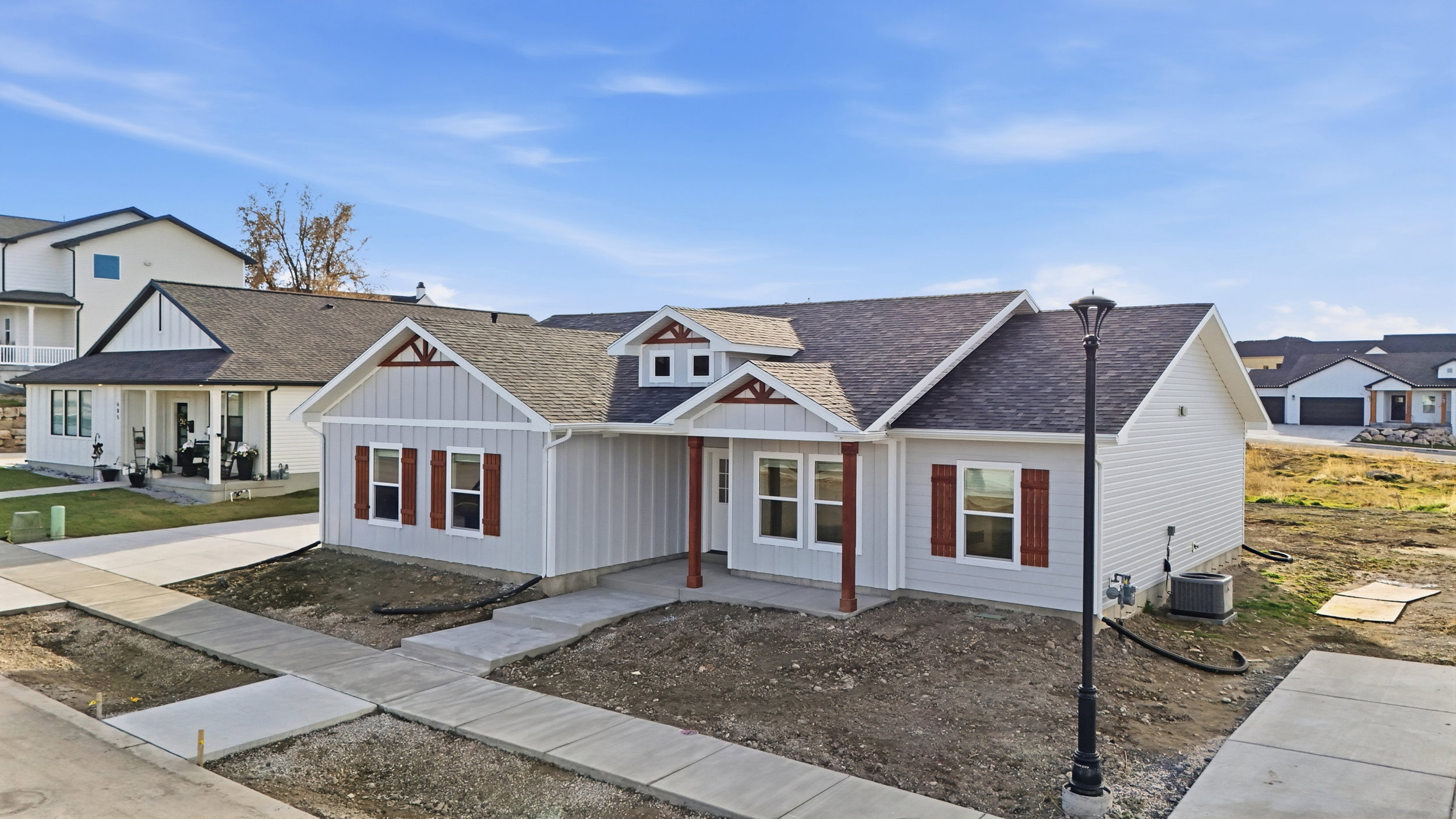 Light gray siding exterior with dark shingle roofing