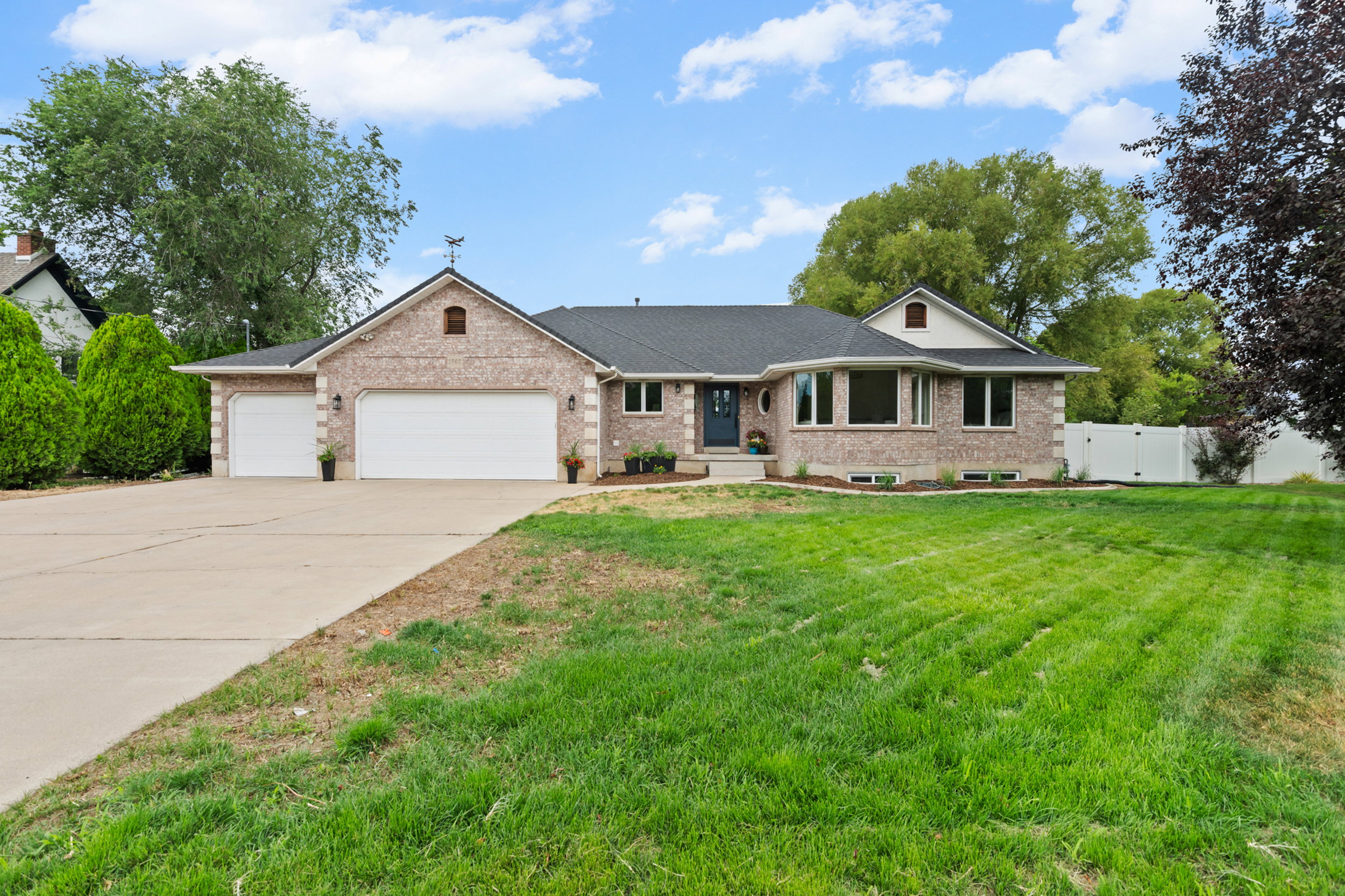 Brick exterior with a dark roof and a two-car garage