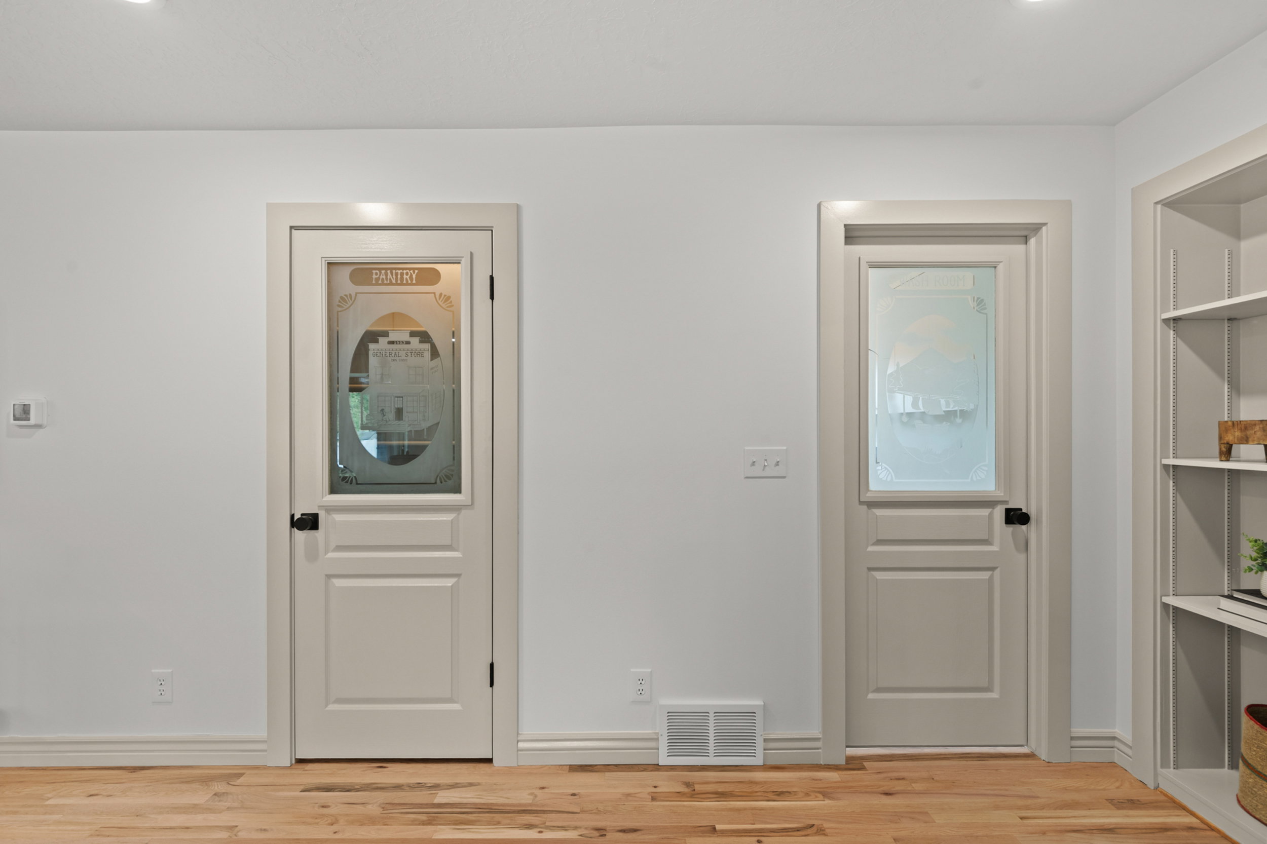 Light wood-finish flooring complements white walls with matching baseboards
