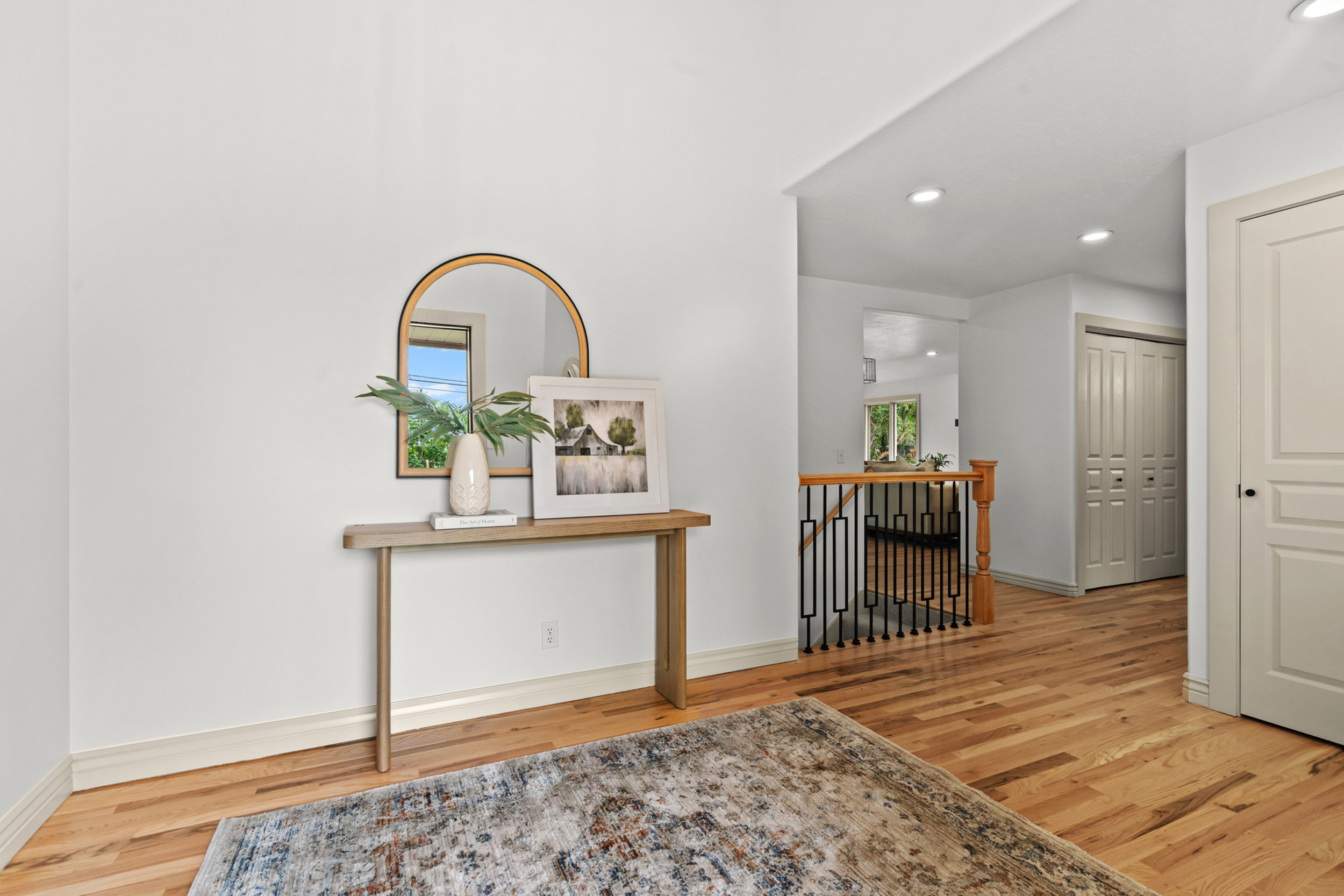 Wood-finish flooring throughout, complemented by a contemporary console table