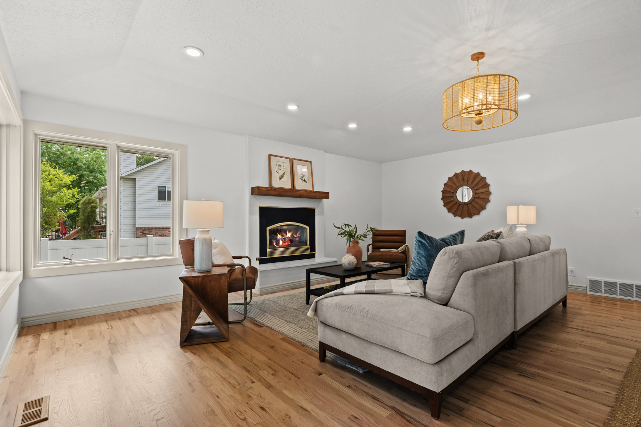 Living area featuring wood-finish flooring and a fireplace with a wood mantel