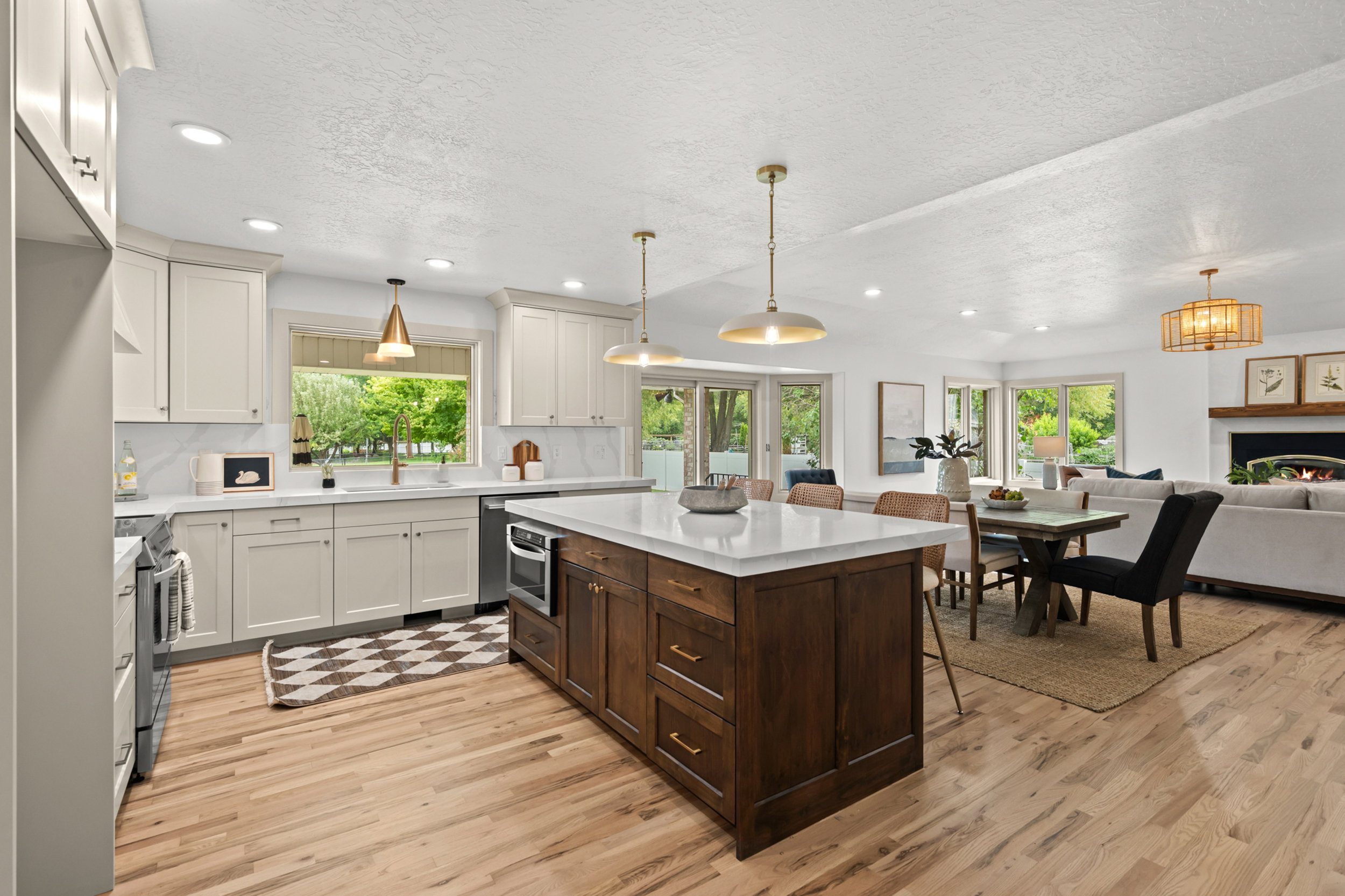 Open-concept kitchen and living area featuring wood-finish flooring