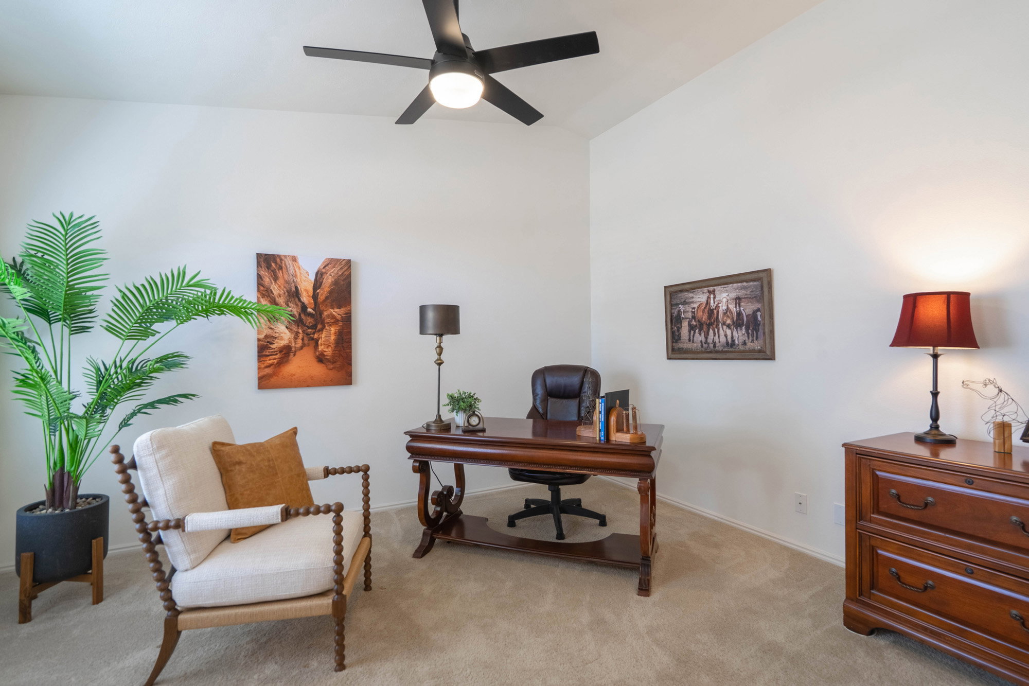 Dedicated workspace featuring vaulted ceilings and recessed lighting