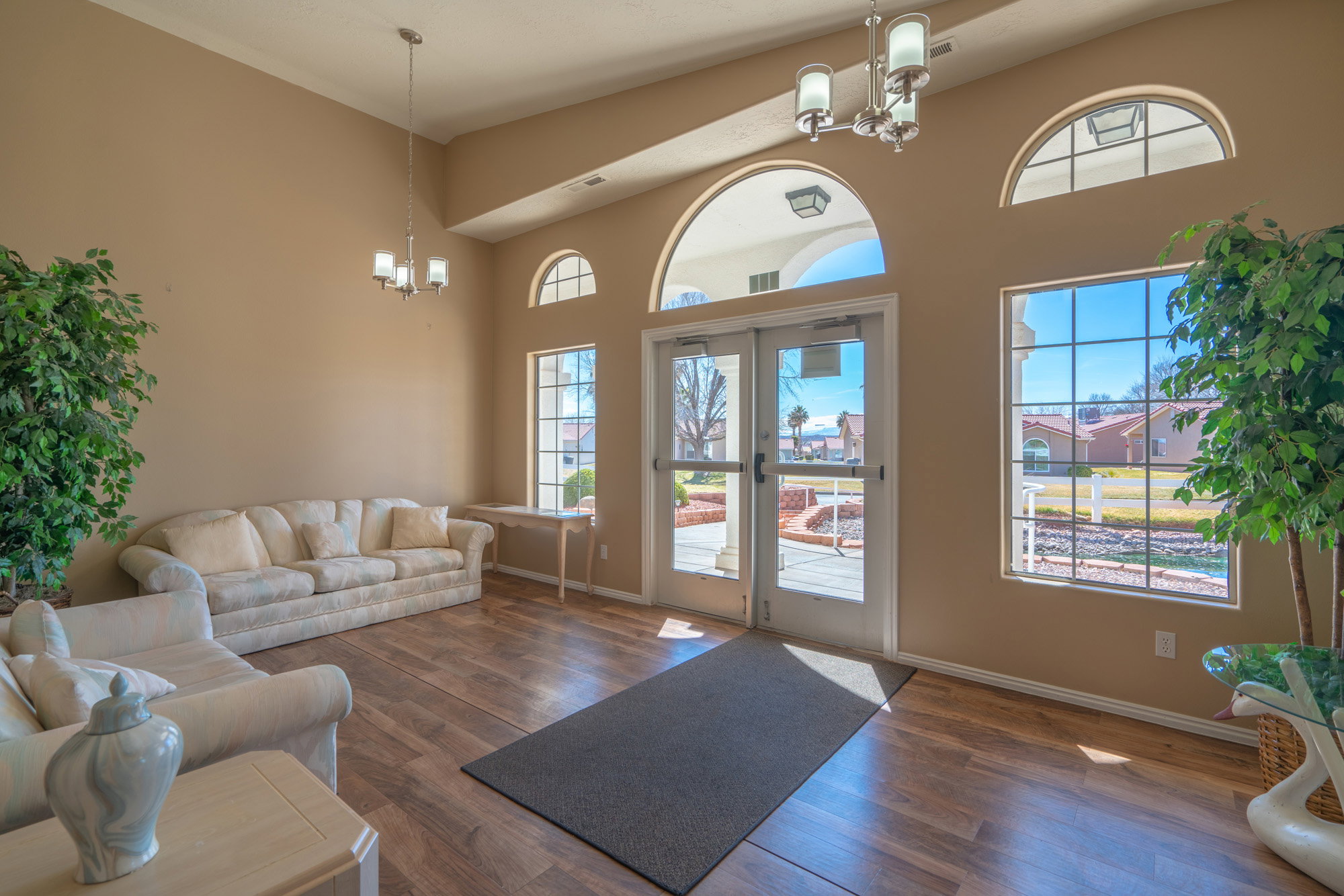 Entry foyer featuring high ceilings and wood-finish flooring