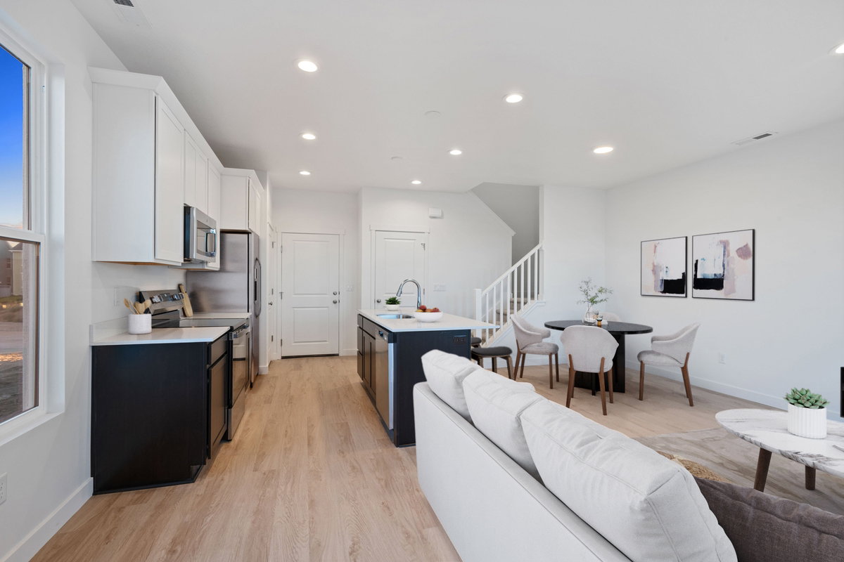 Open-concept living area with a contemporary kitchen, dining space, and living room
