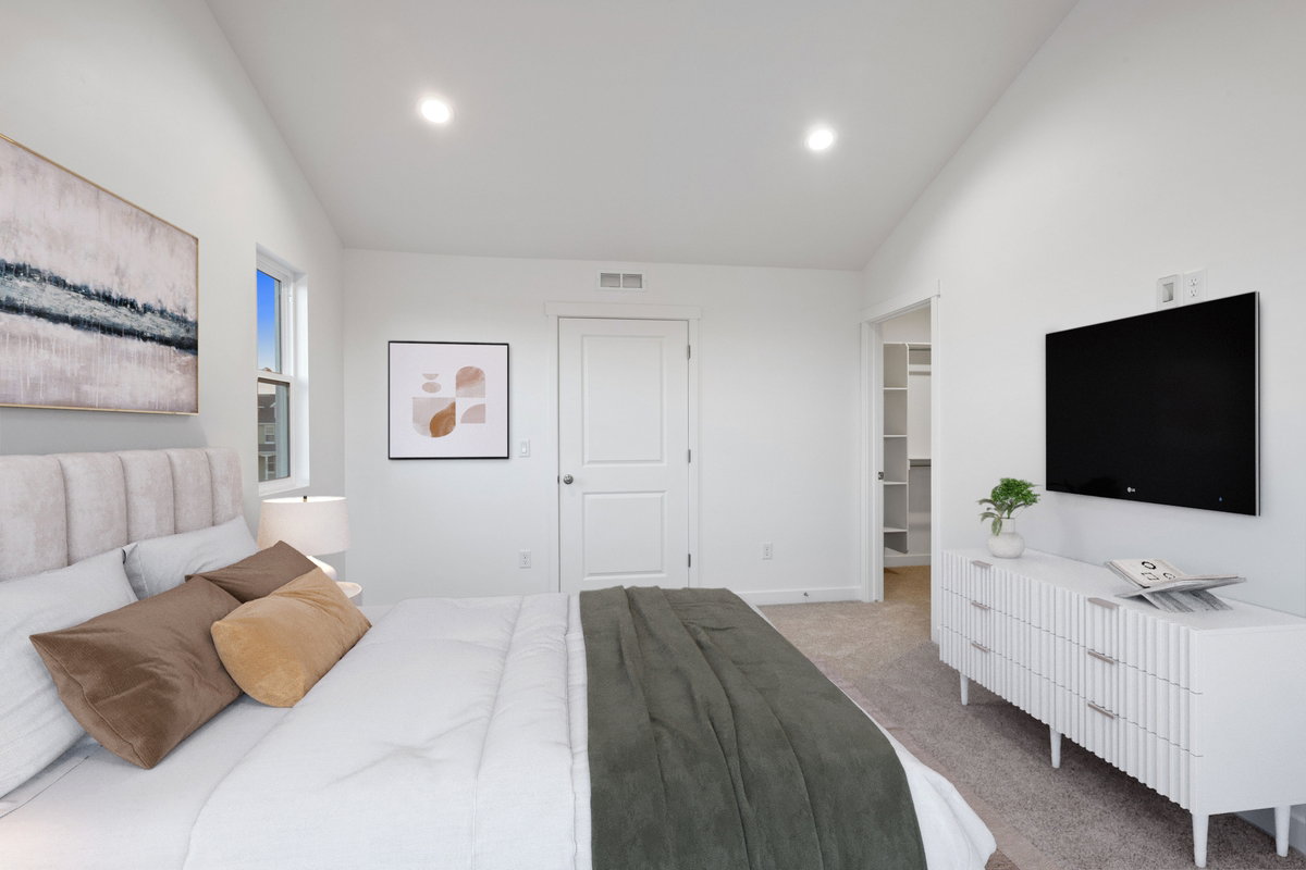 Bedroom featuring light gray carpeting, crisp white walls, recessed ceiling lighting, a window, and an open closet with shelving