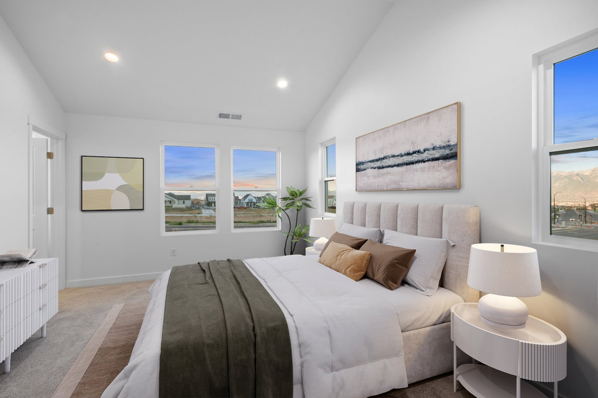 Bedroom featuring a vaulted ceiling with recessed lighting, multiple windows, and light-tone carpeting