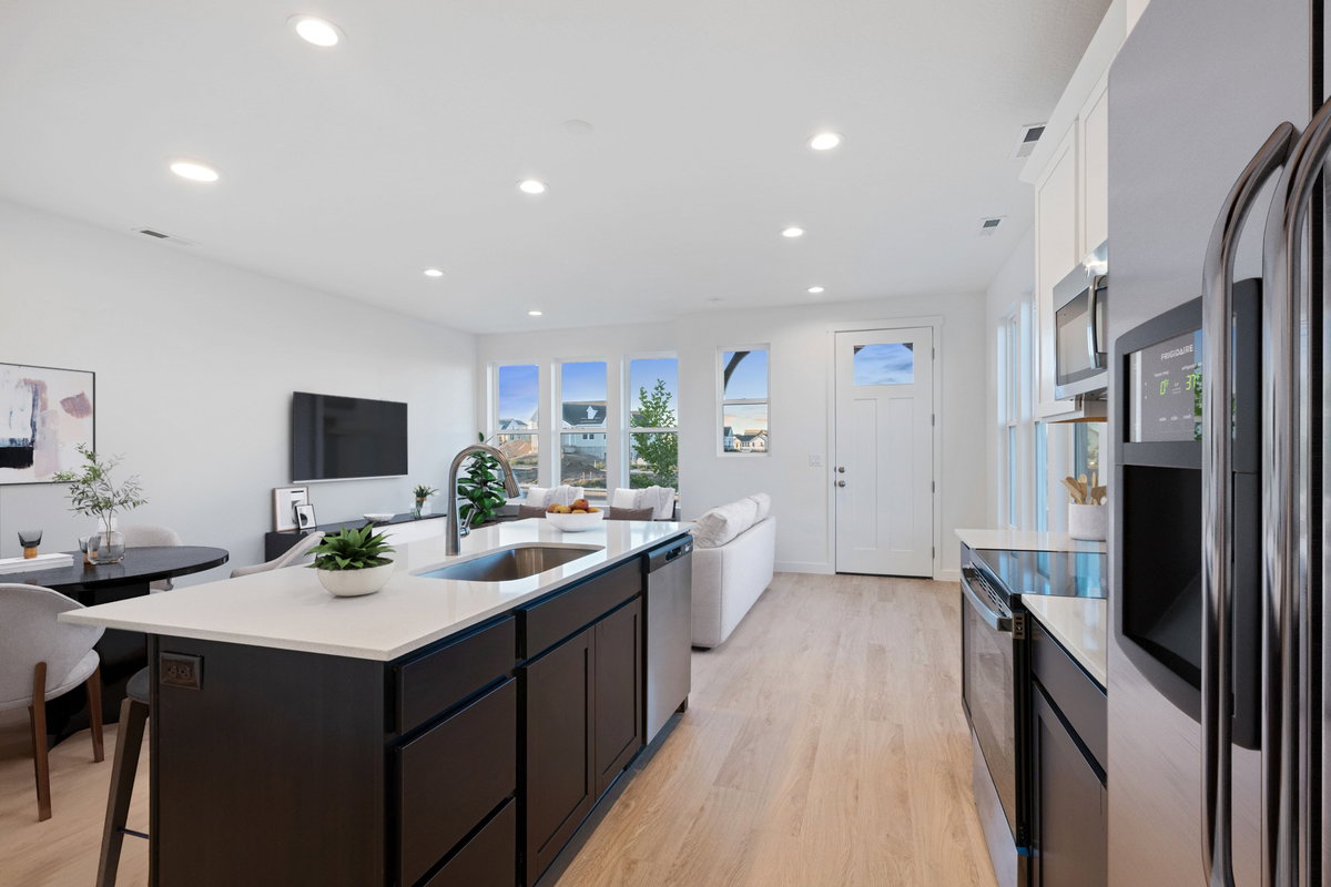 Open-concept living space with light wood-finish flooring