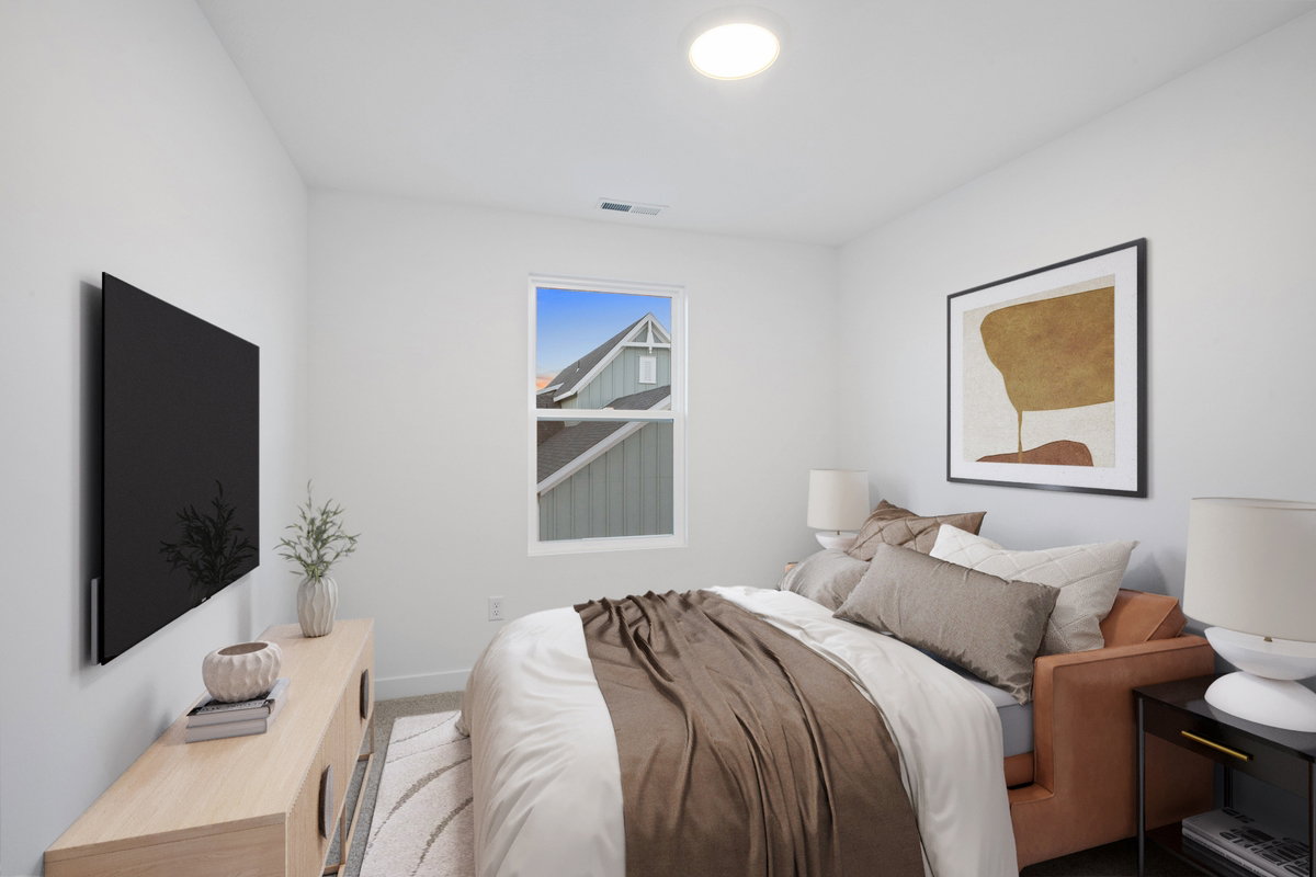 Bedroom featuring a window with exterior residential views, recessed ceiling lighting, and light-toned wall finishes